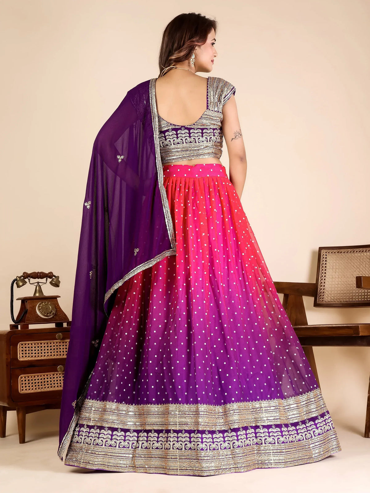 Woman in a pink and purple ombre designer lehenga choli with silver embroidery