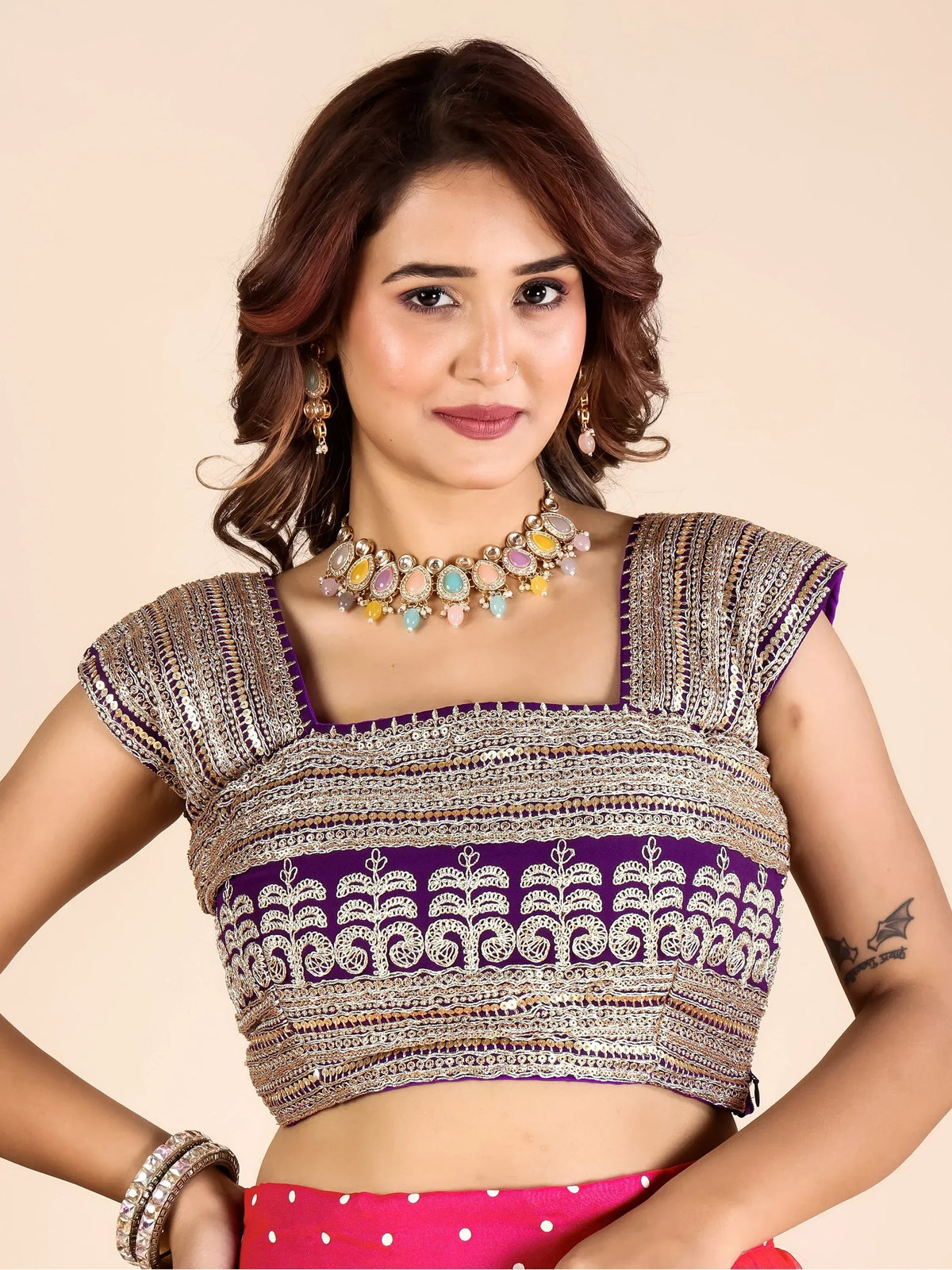 Woman wearing a purple and silver embroidered designer lehenga choli blouse and ethnic necklace