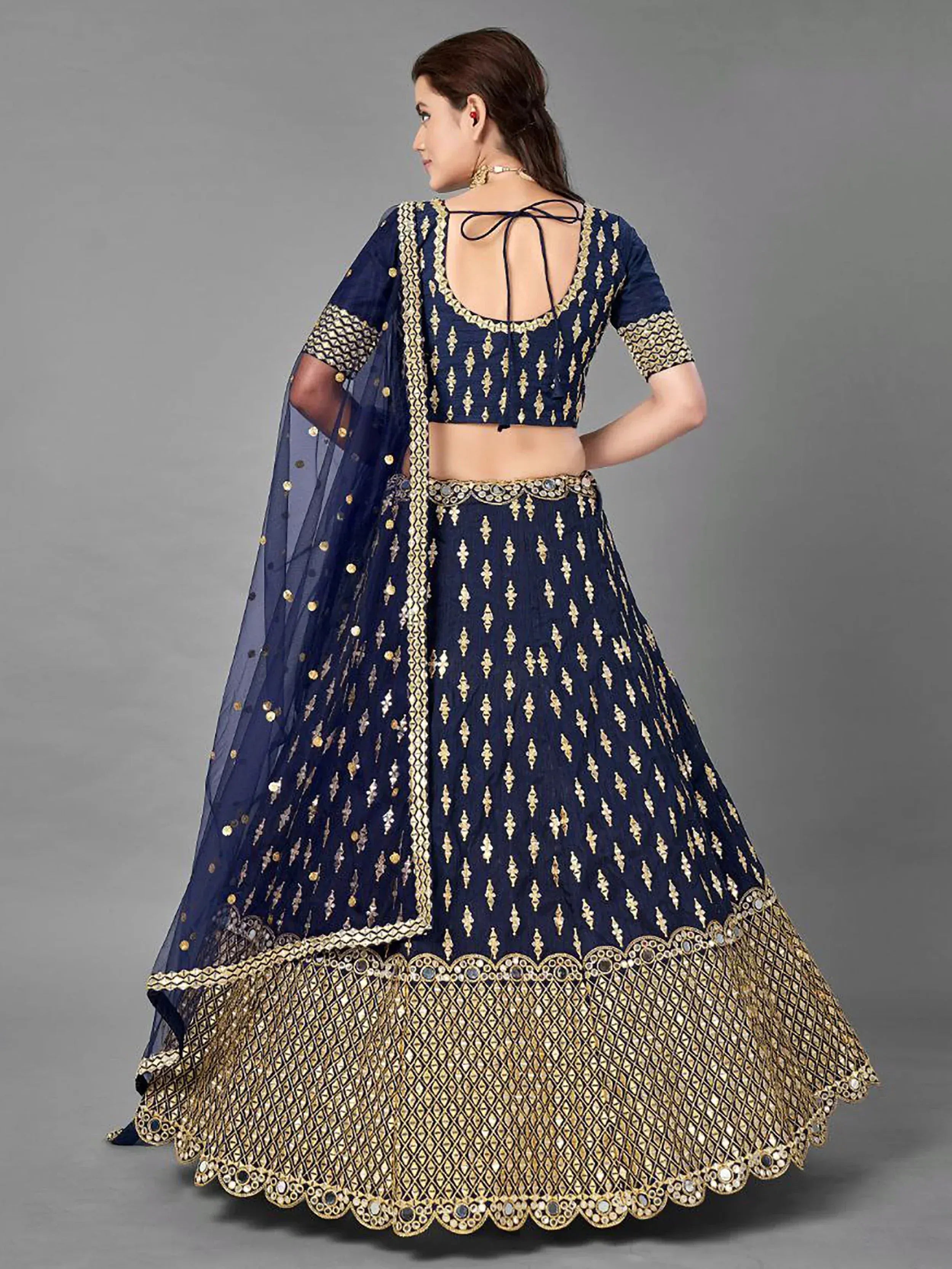 Navy blue designer lehenga choli with gold embroidery and mirror work, back view