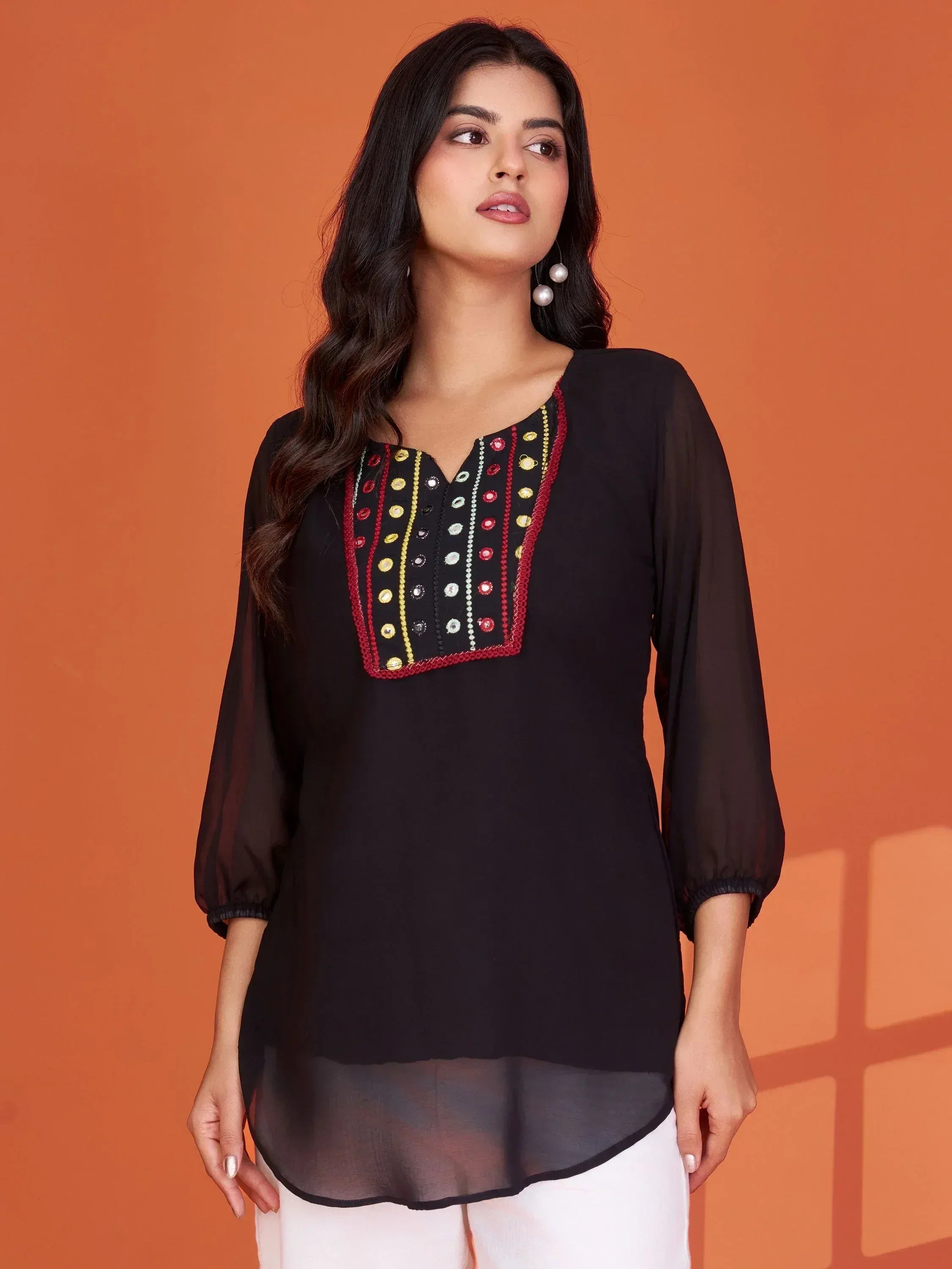 Black ethnic kurta with colorful mirror and thread embroidery, paired with white pants