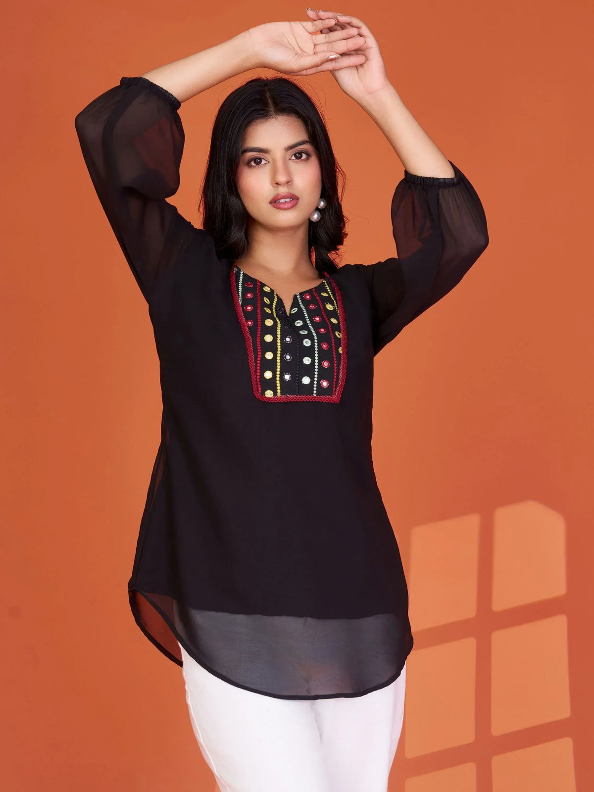 Black ethnic kurti with colorful mirror embroidery and sheer sleeves, paired with white pants