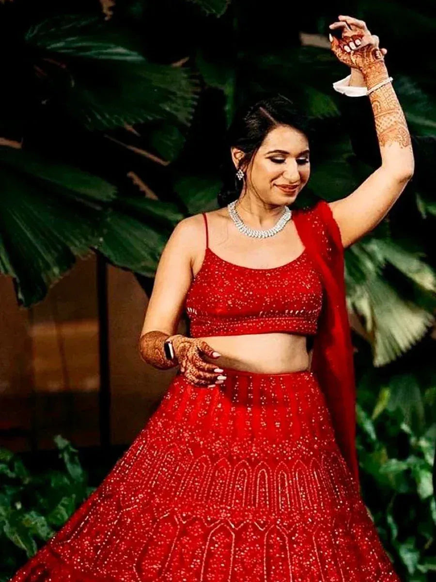 Red embroidered lehenga choli with henna hands, perfect for Indian weddings and festive occasions