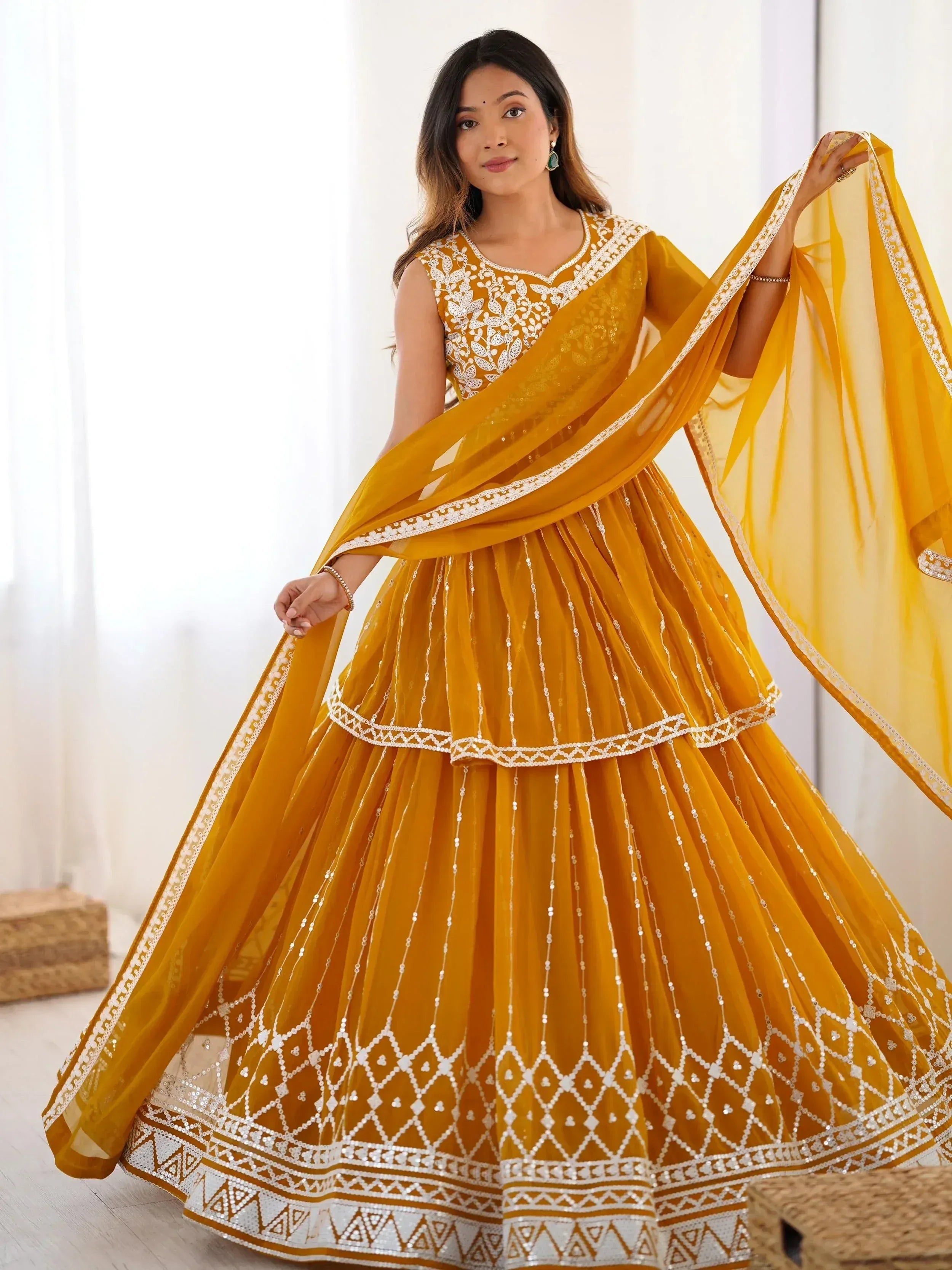 Mustard yellow designer lehenga choli with white embroidery and sequin work, perfect for Indian ethnic occasions.