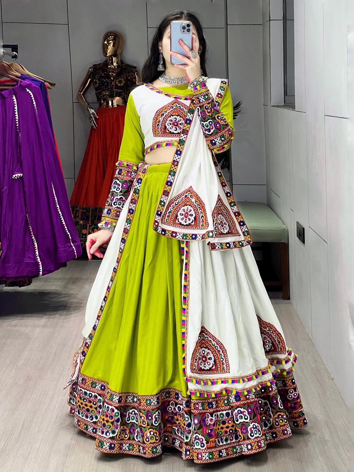 Vibrant green and white embroidered lehenga choli with mirror work, perfect for Indian ethnic wear occasions.