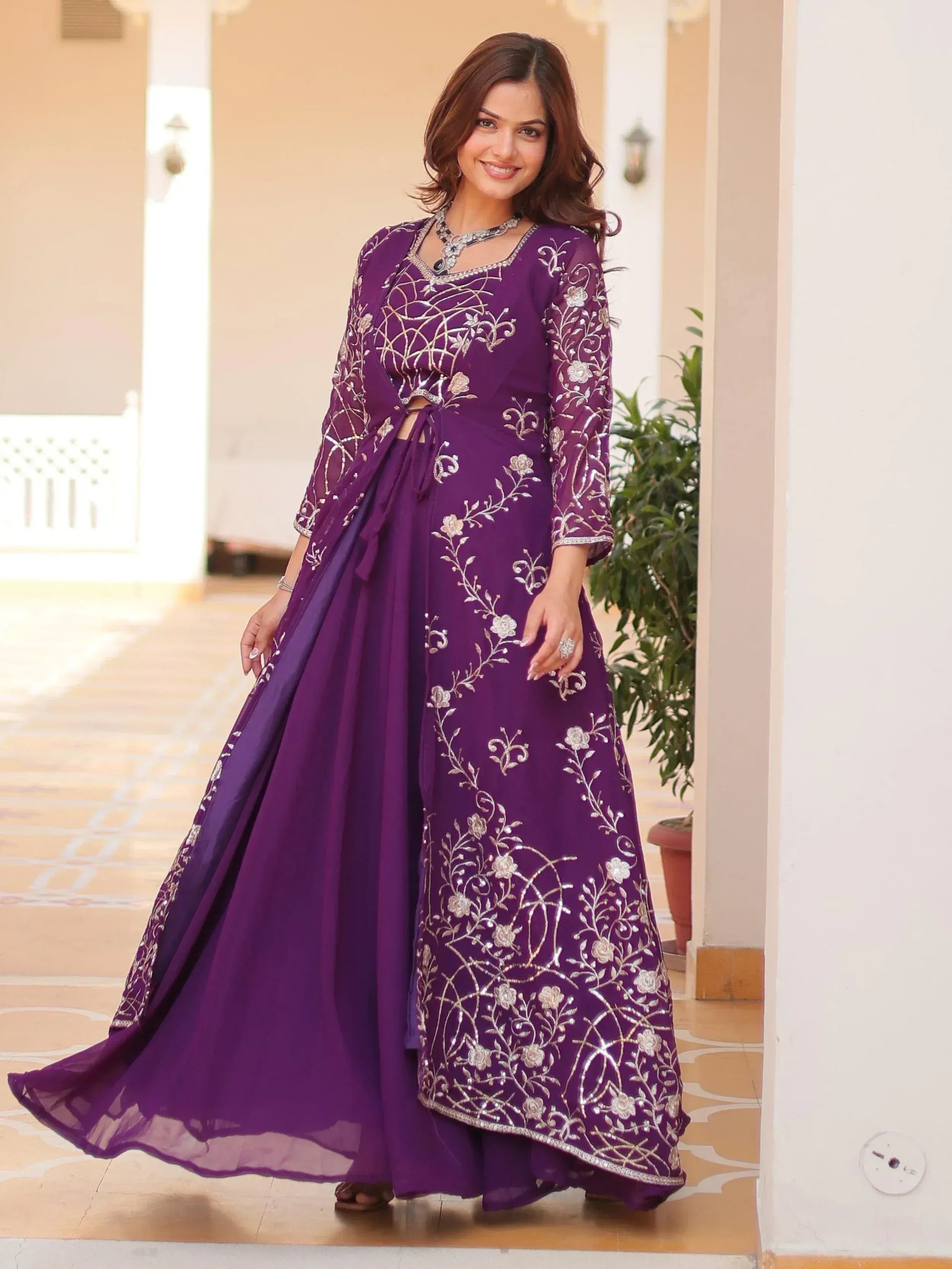 Purple embroidered ethnic gown with floral designs, perfect for Indian festive occasions