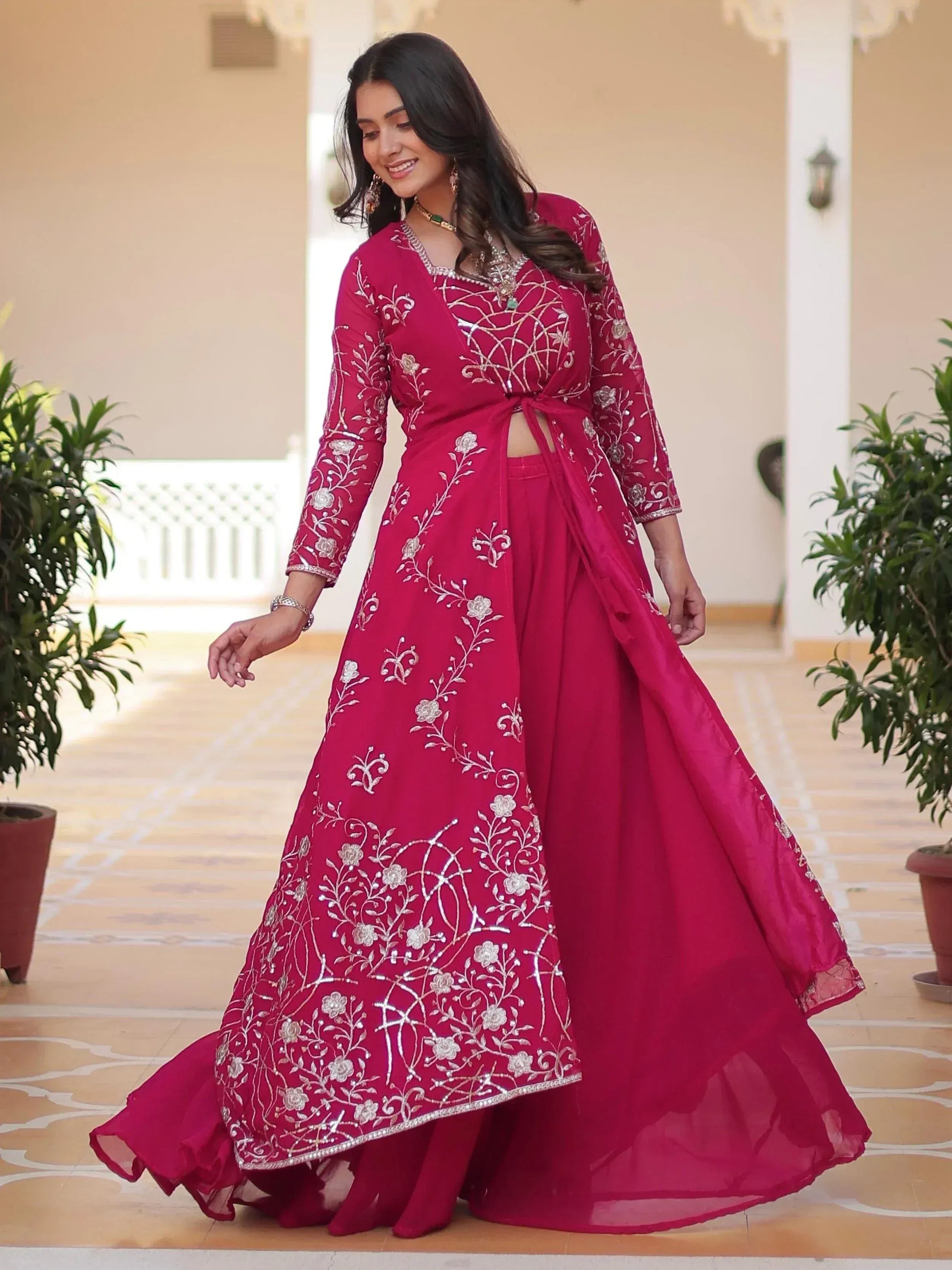Elegant maroon ethnic gown with silver floral embroidery, perfect for Indian festive occasions