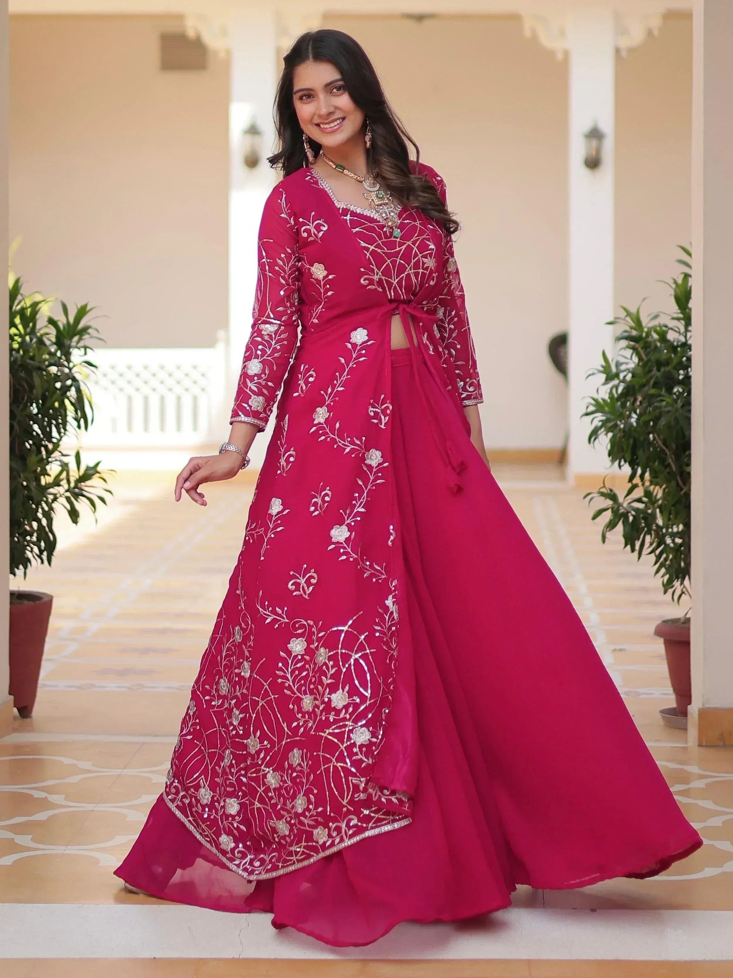 Elegant pink embroidered lehenga choli with floral designs, perfect for Indian ethnic wear