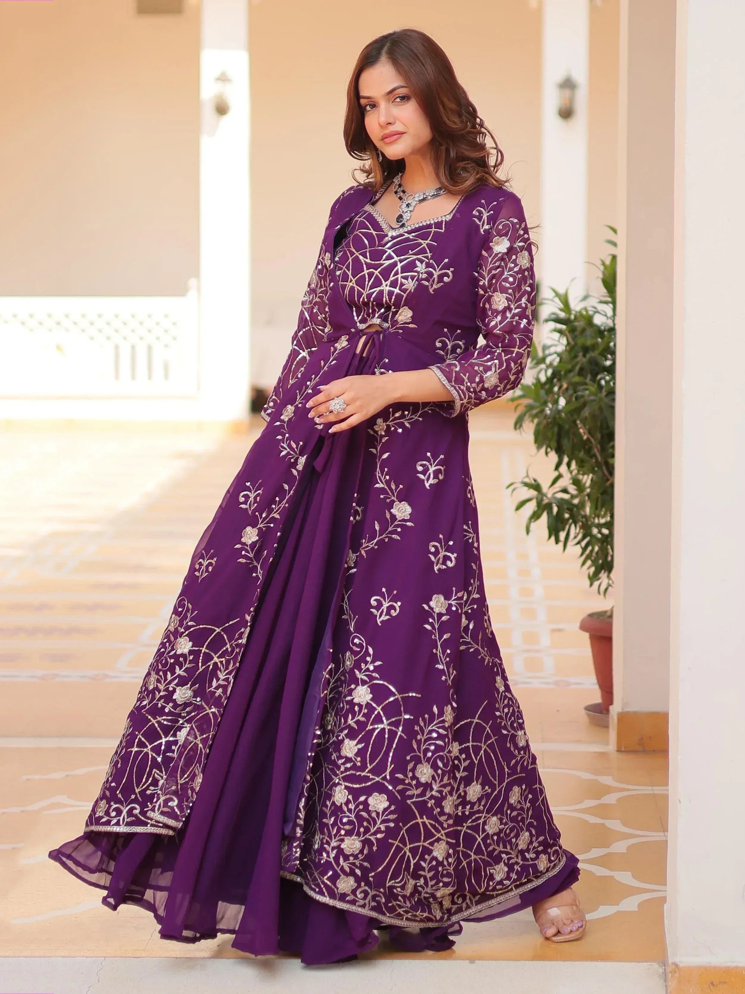 Purple embroidered ethnic gown with floral designs, perfect for Indian celebrations