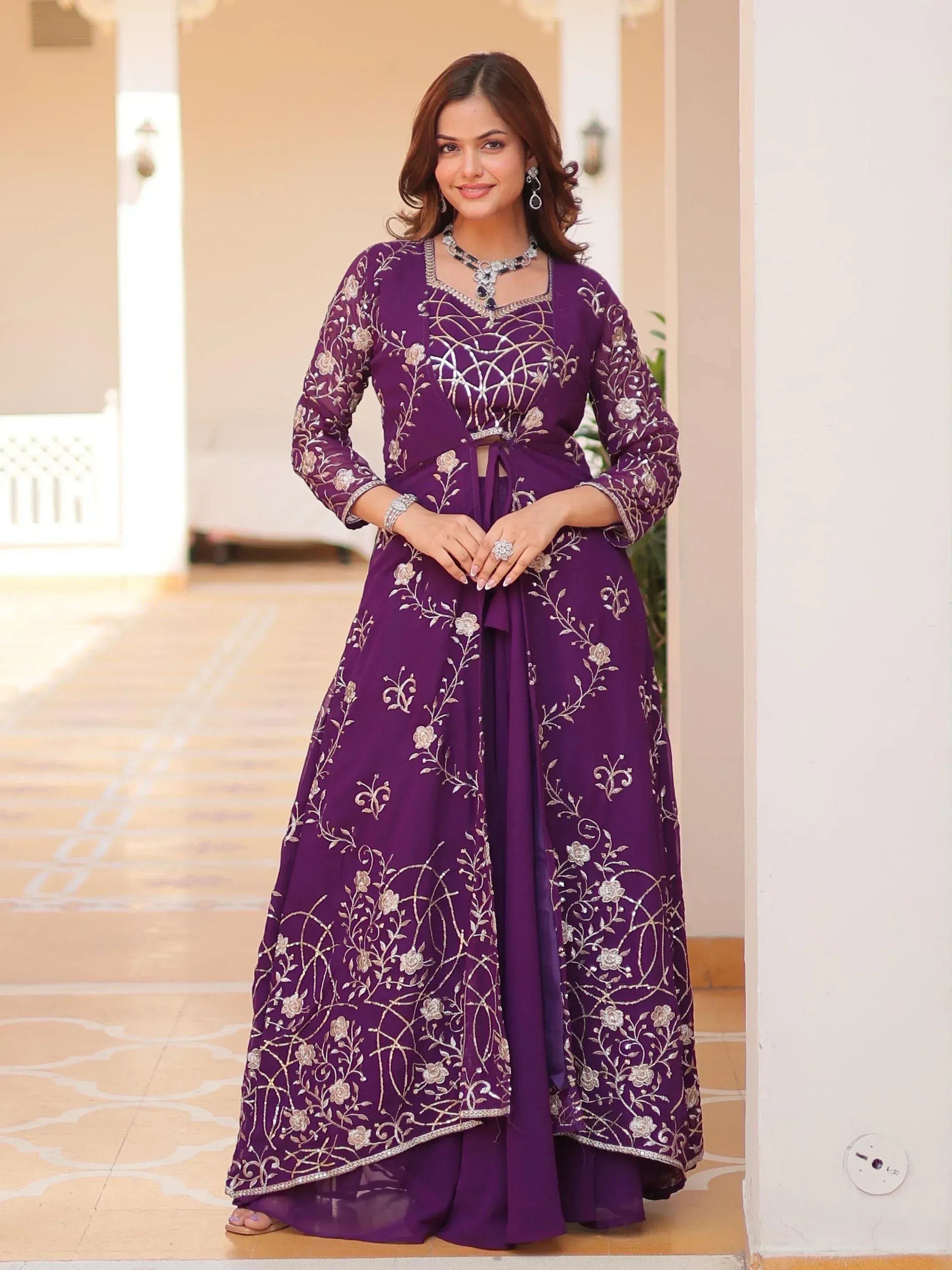 Purple embroidered ethnic gown with floral designs, perfect for Indian festive occasions.