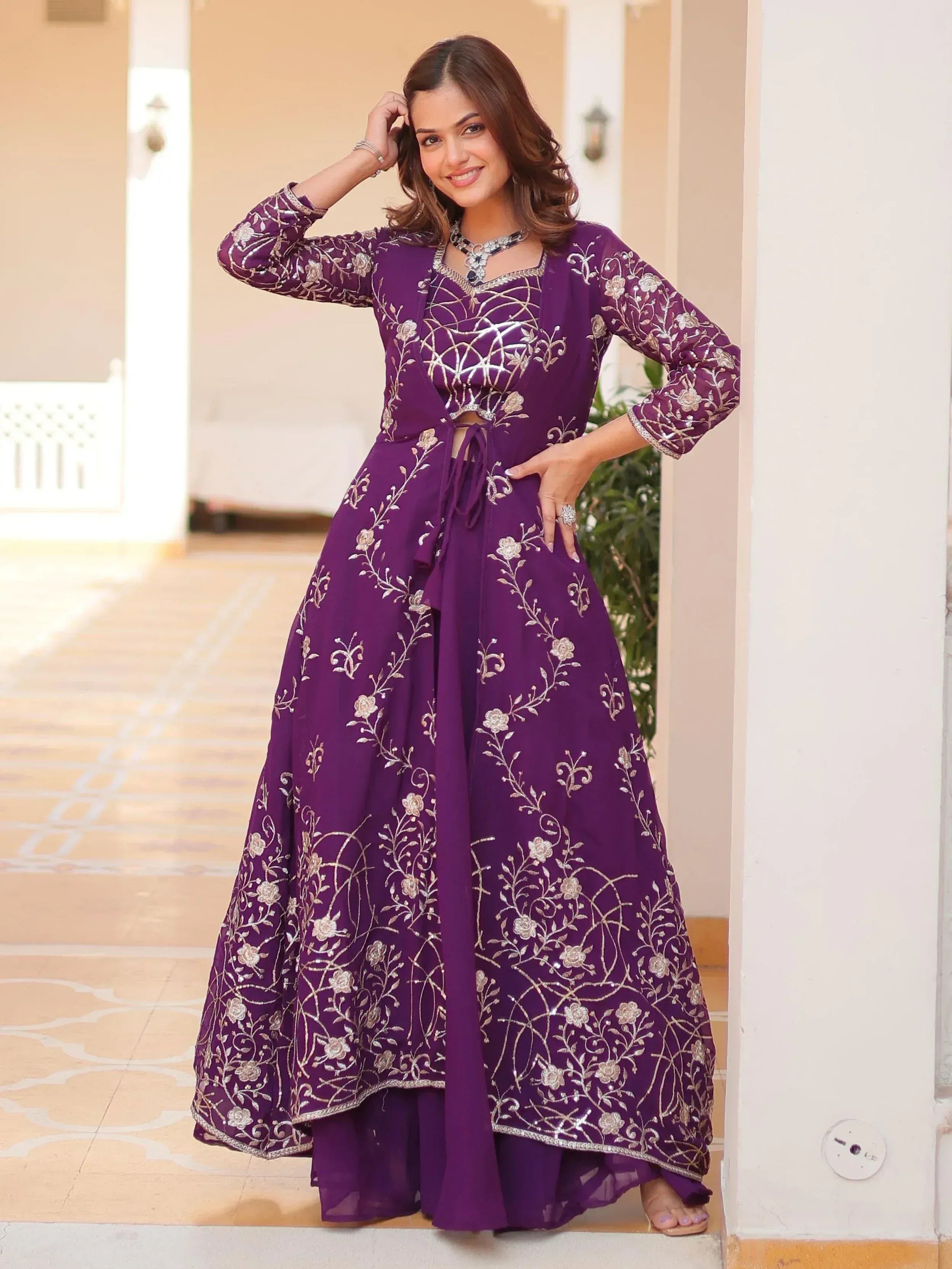 Purple embroidered ethnic gown with floral designs, perfect for Indian celebrations and events.