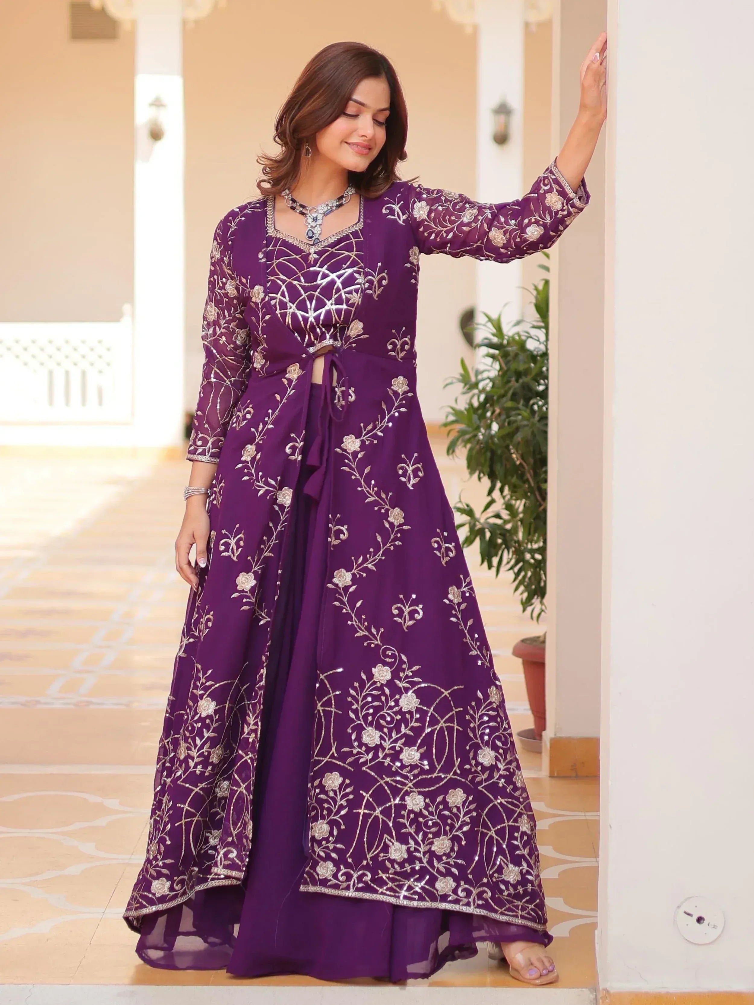 Purple embroidered ethnic gown with floral designs, perfect for Indian festive occasions