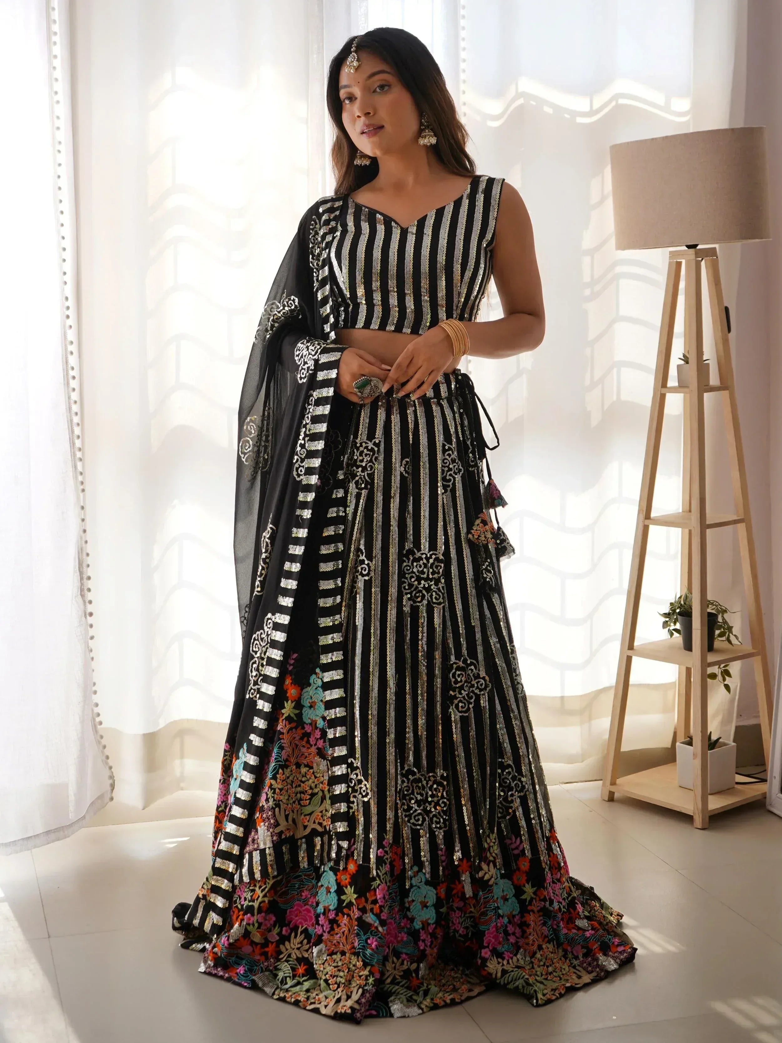 Black and gold striped lehenga choli with floral embroidery, perfect for Indian ethnic wear occasions