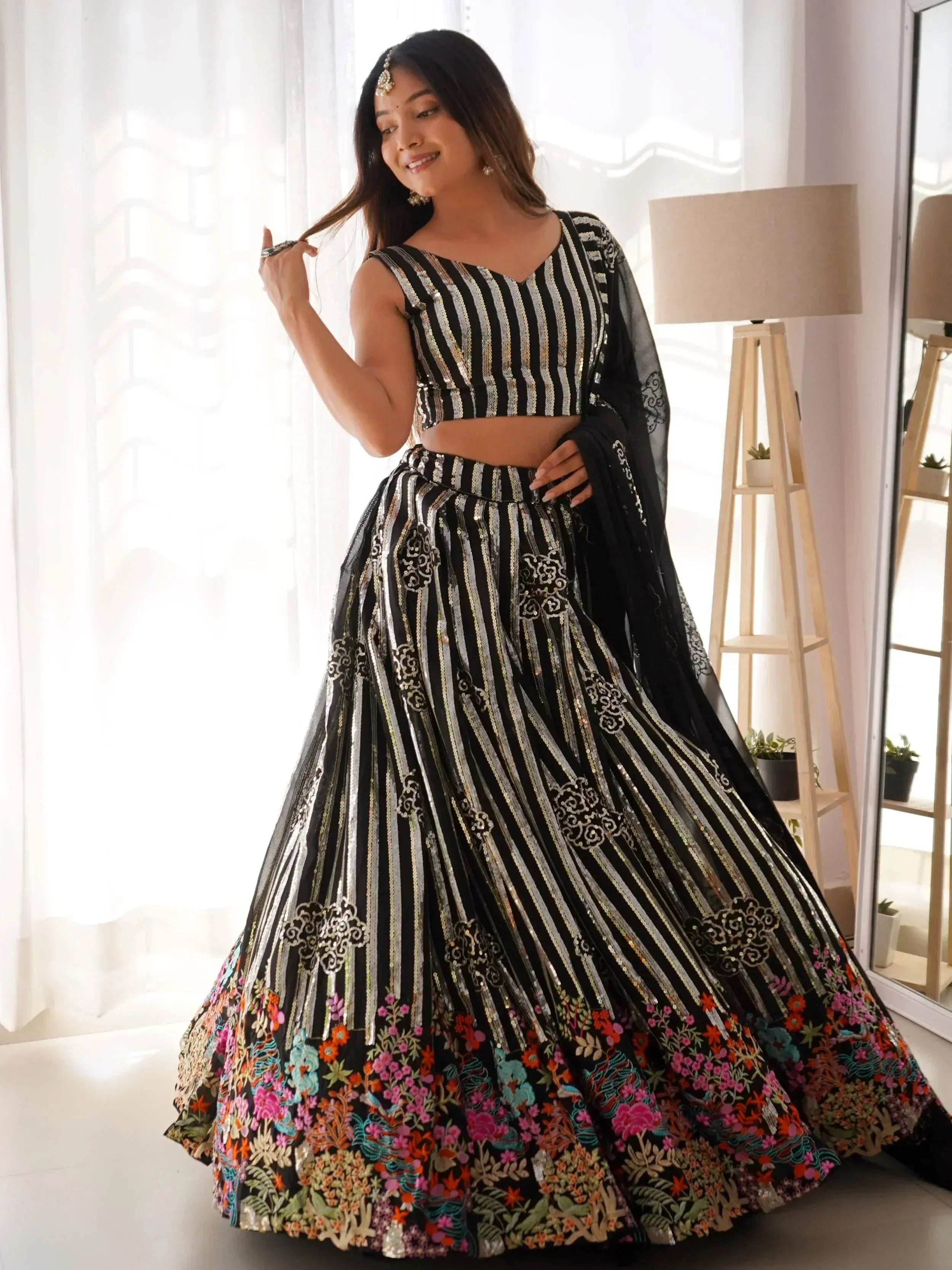 Black and gold striped lehenga choli with floral embroidery, perfect for Indian ethnic wear events.