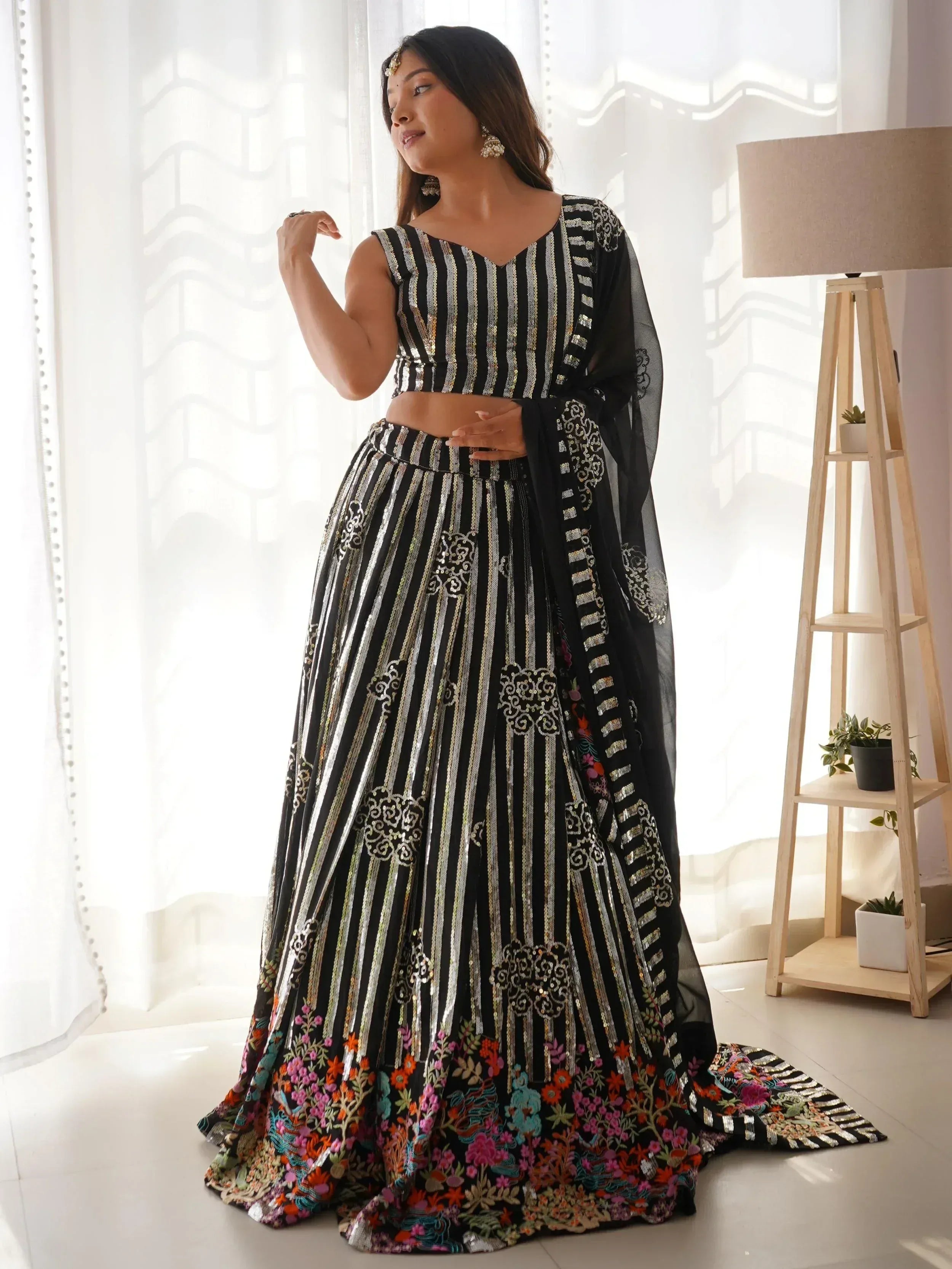 Black and silver striped designer lehenga choli with floral embroidery and sheer dupatta, perfect for Indian ethnic wear.