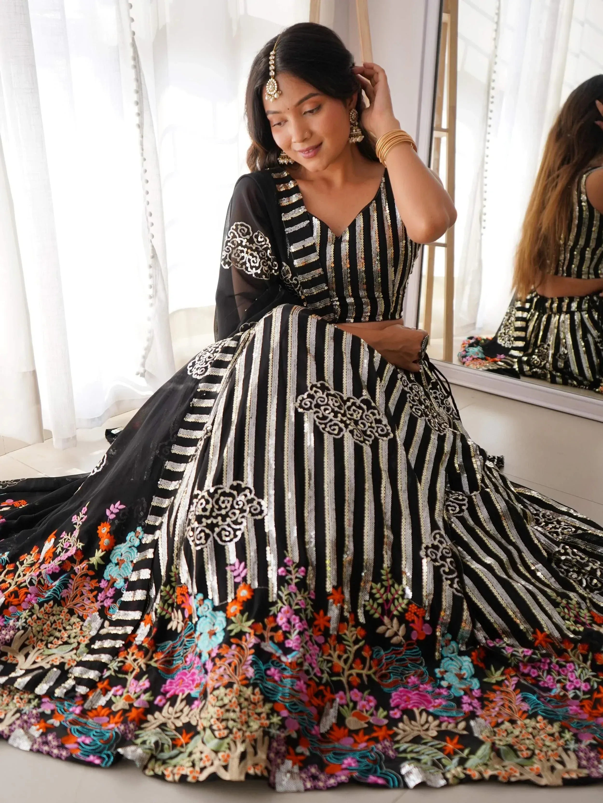 Black and gold striped designer lehenga with floral embroidery, perfect for Indian ethnic wear occasions