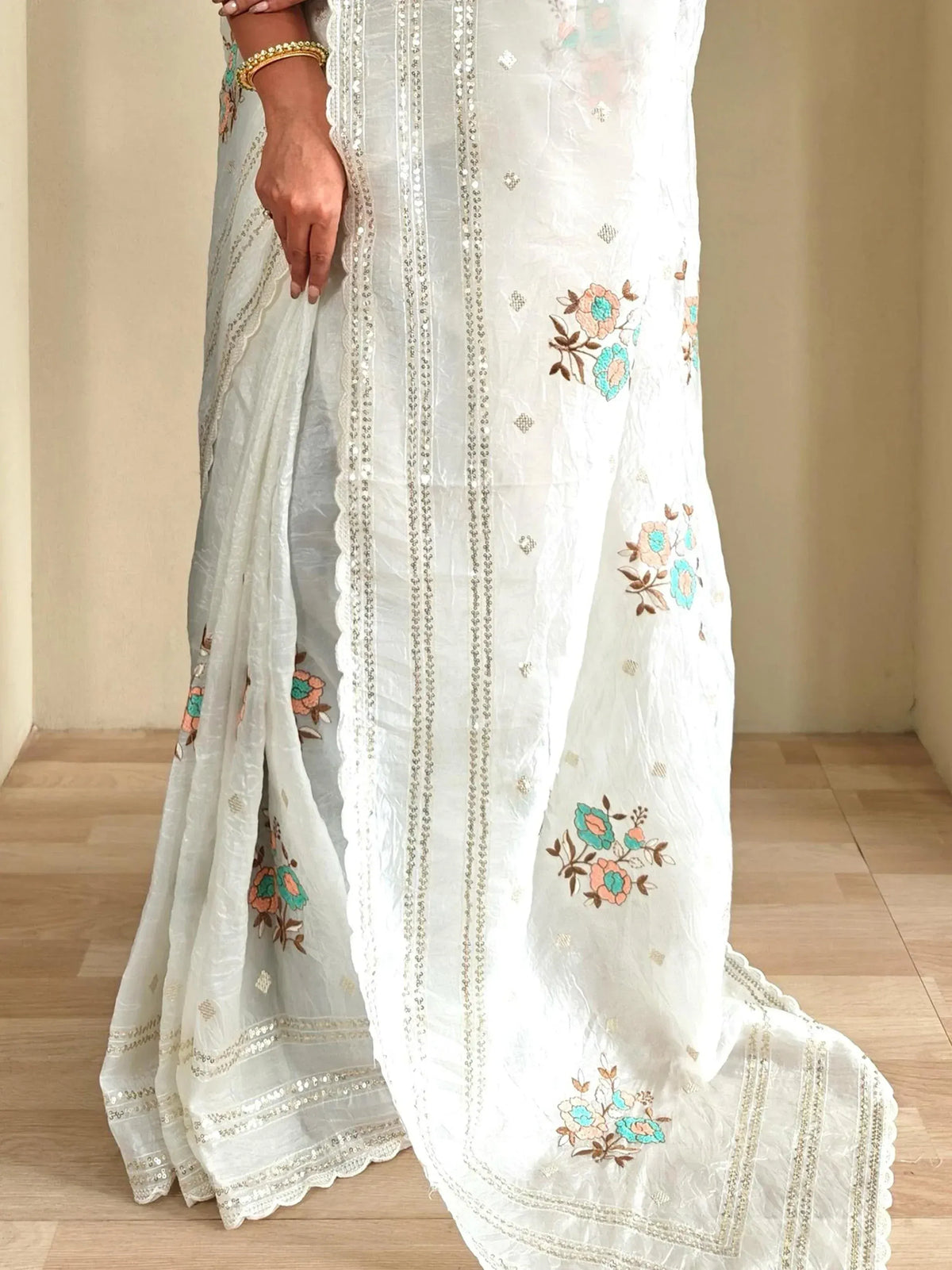 White floral embroidered saree with sequin detailing, perfect for ethnic occasions