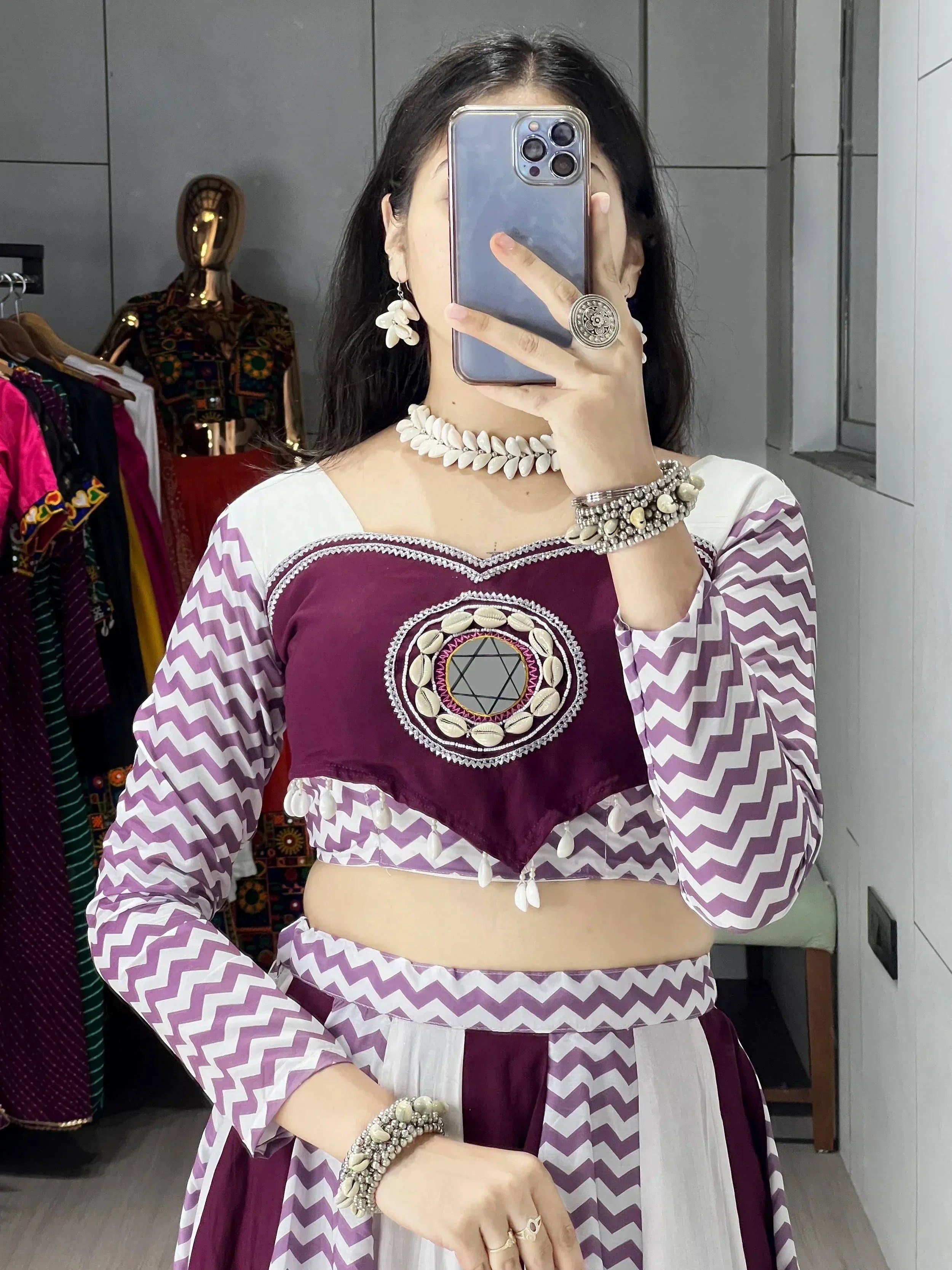 Purple and white chevron print ethnic crop top with shell mirror embroidery, paired with matching skirt and traditional jewelry