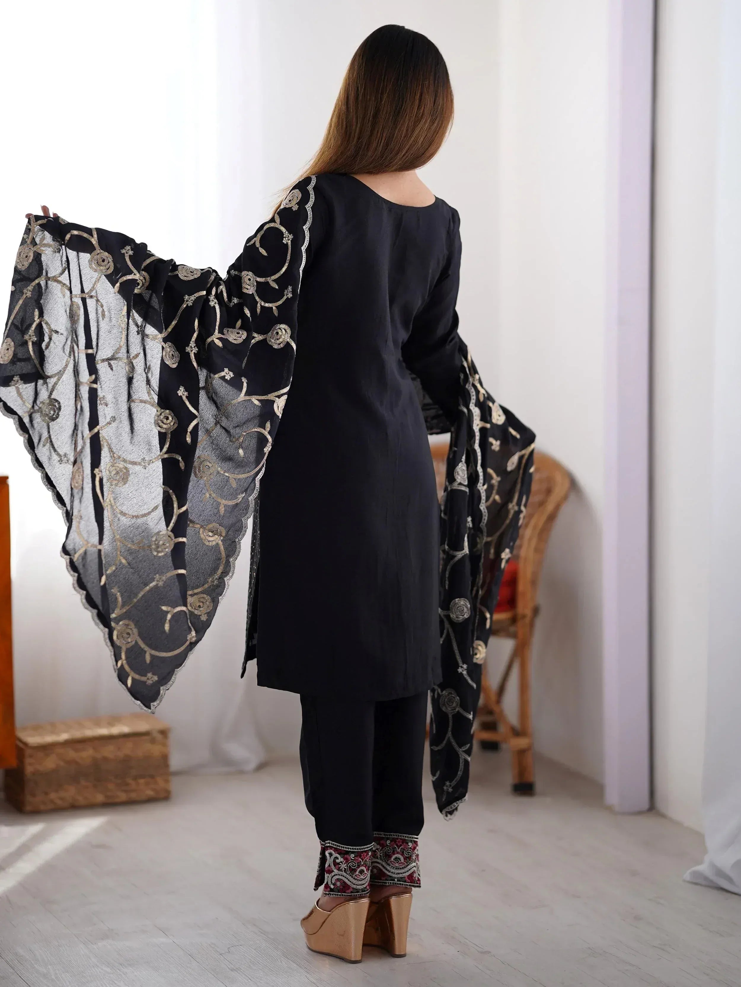 Black ethnic kurta with gold floral embroidery, flared sleeves, and matching pants for women