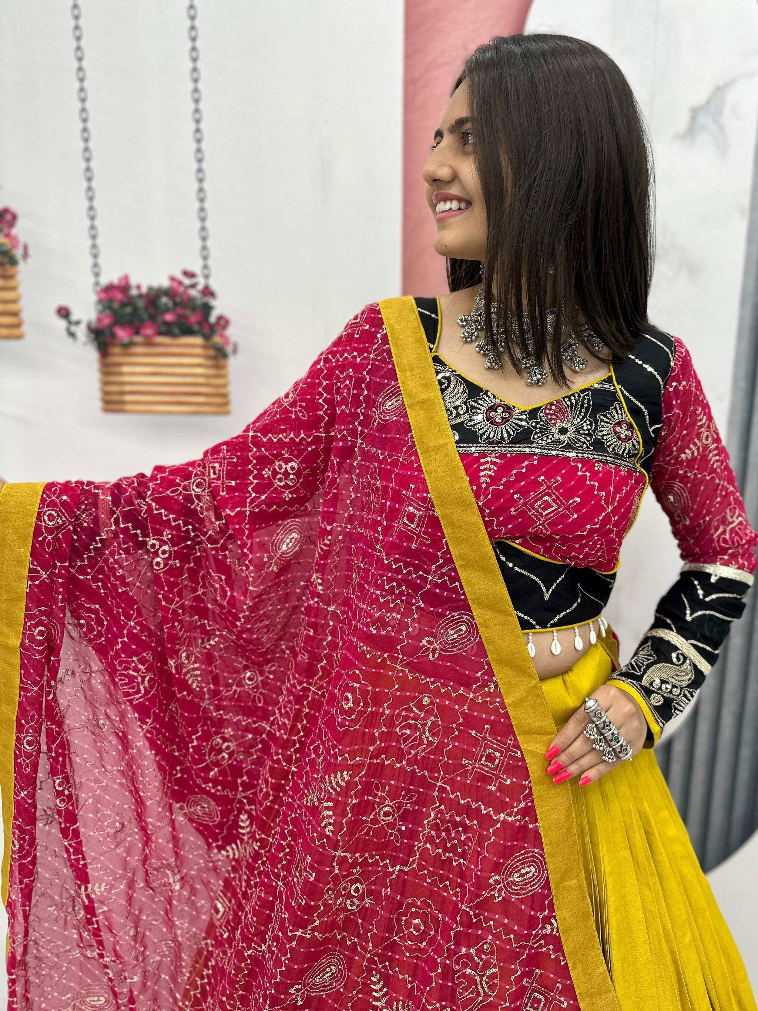 Vibrant pink and yellow ethnic lehenga choli with intricate embroidery and gold detailing
