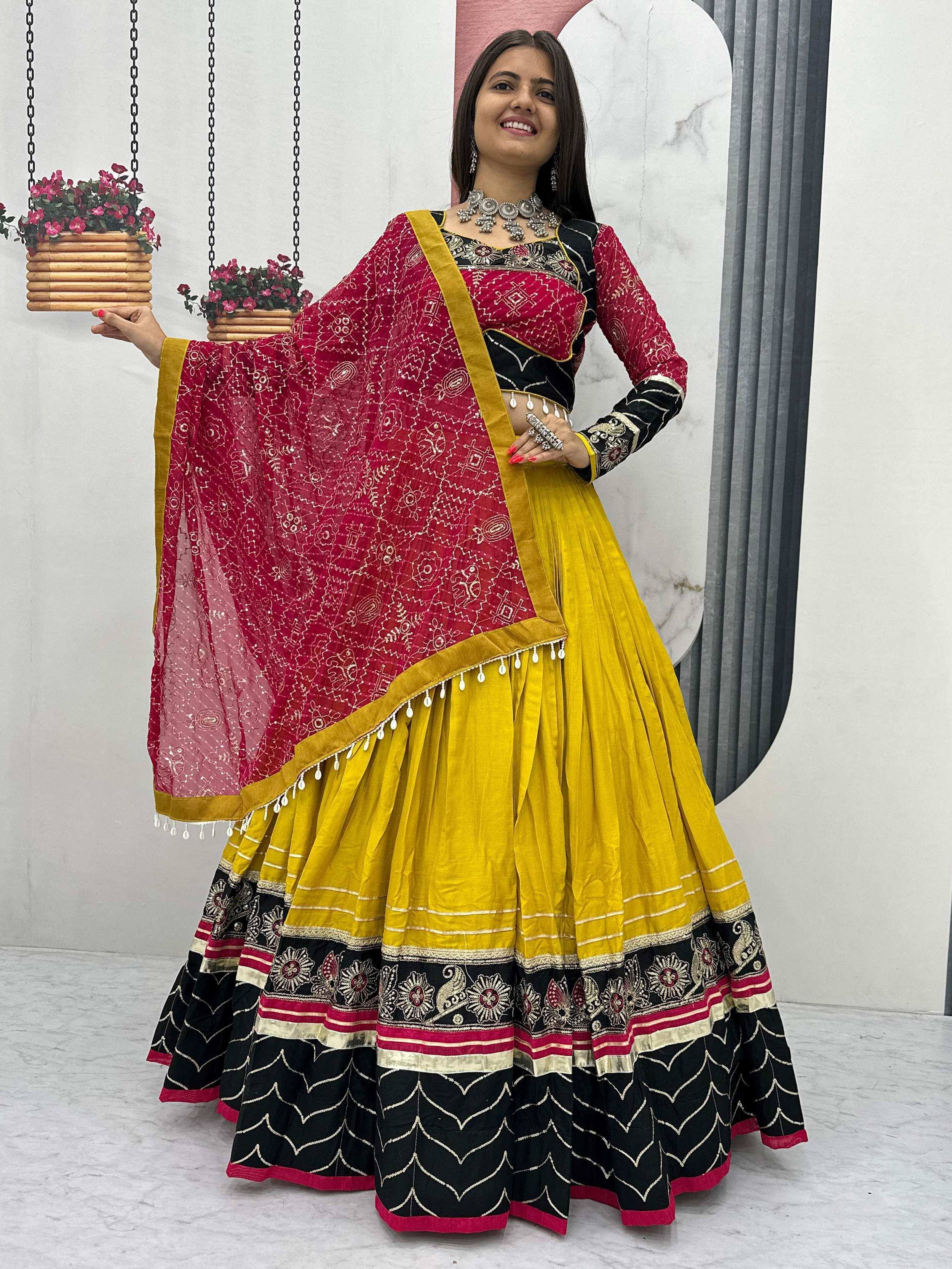 Vibrant yellow and red embroidered lehenga choli with black detailing and dupatta