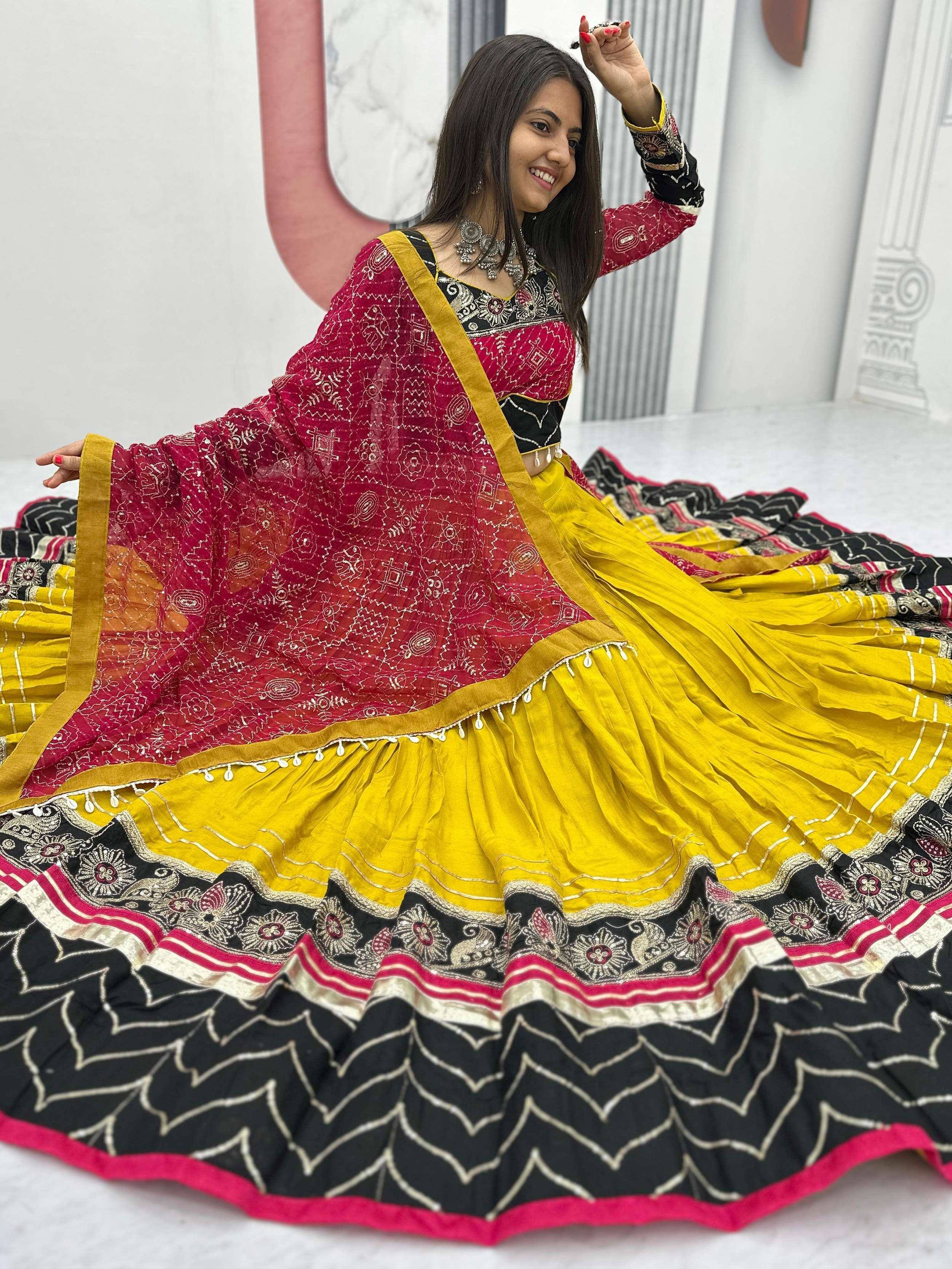 Woman in vibrant yellow and red ethnic lehenga choli with intricate embroidery and dupatta, perfect for festive occasions.