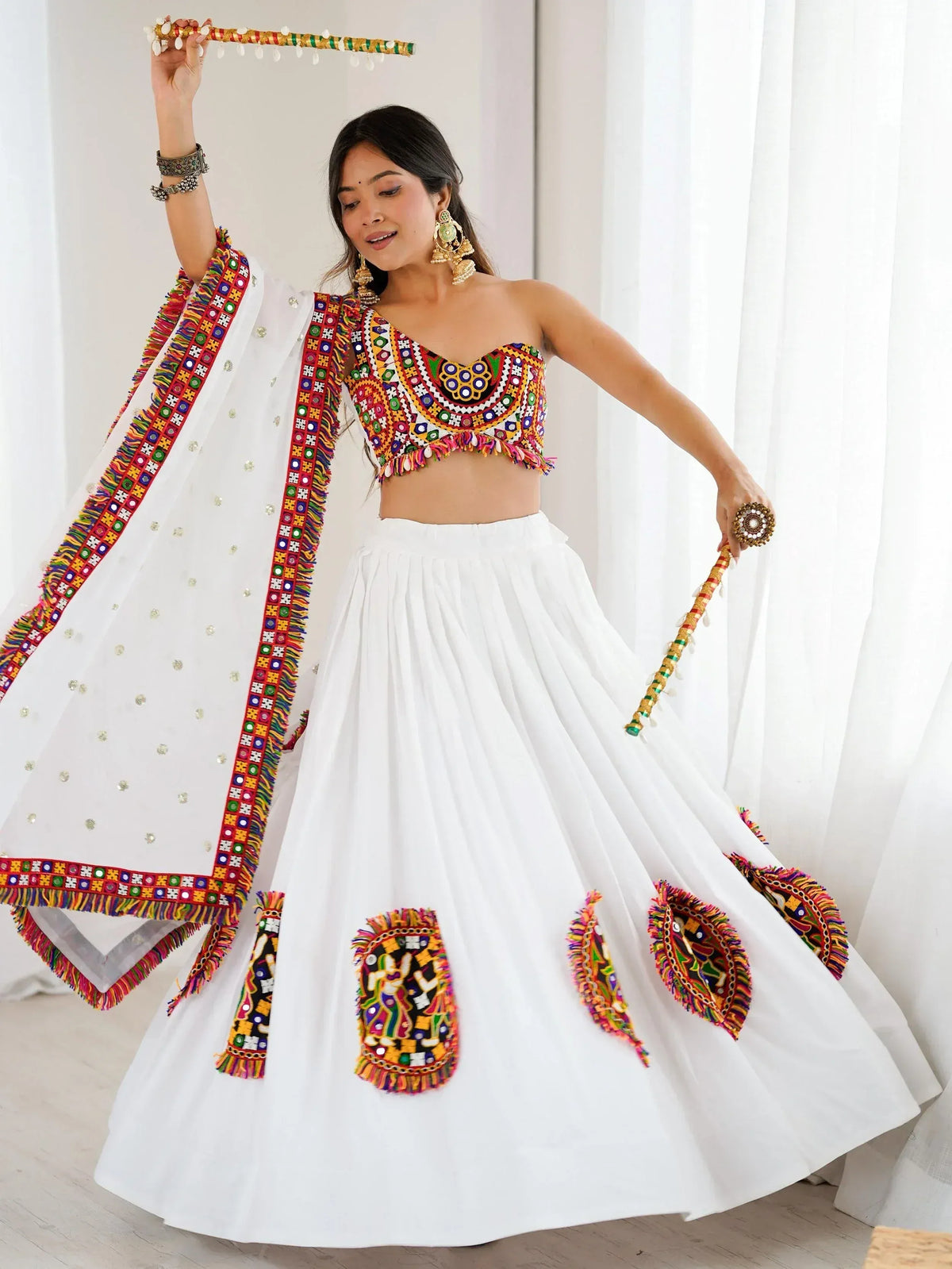 White ethnic lehenga choli with colorful mirror work, perfect for Indian festivals and weddings