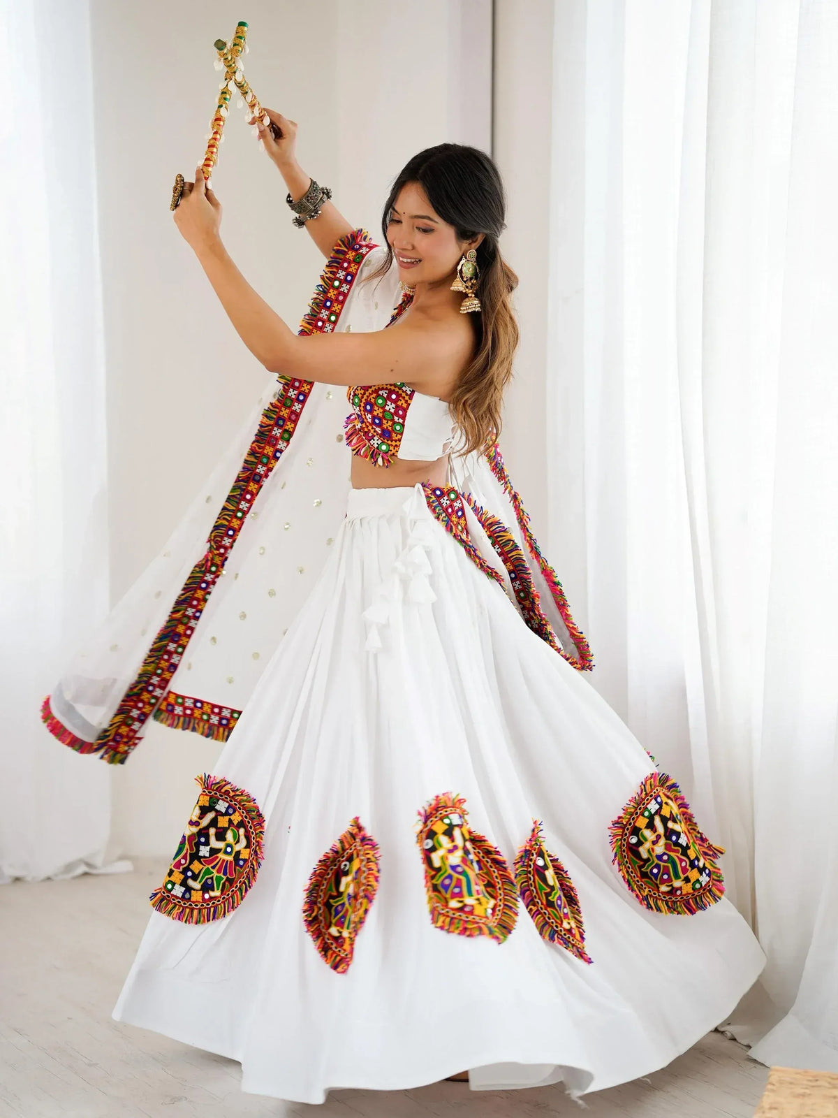 White ethnic lehenga choli with colorful mirror work and dupatta, perfect for Indian festivals and weddings