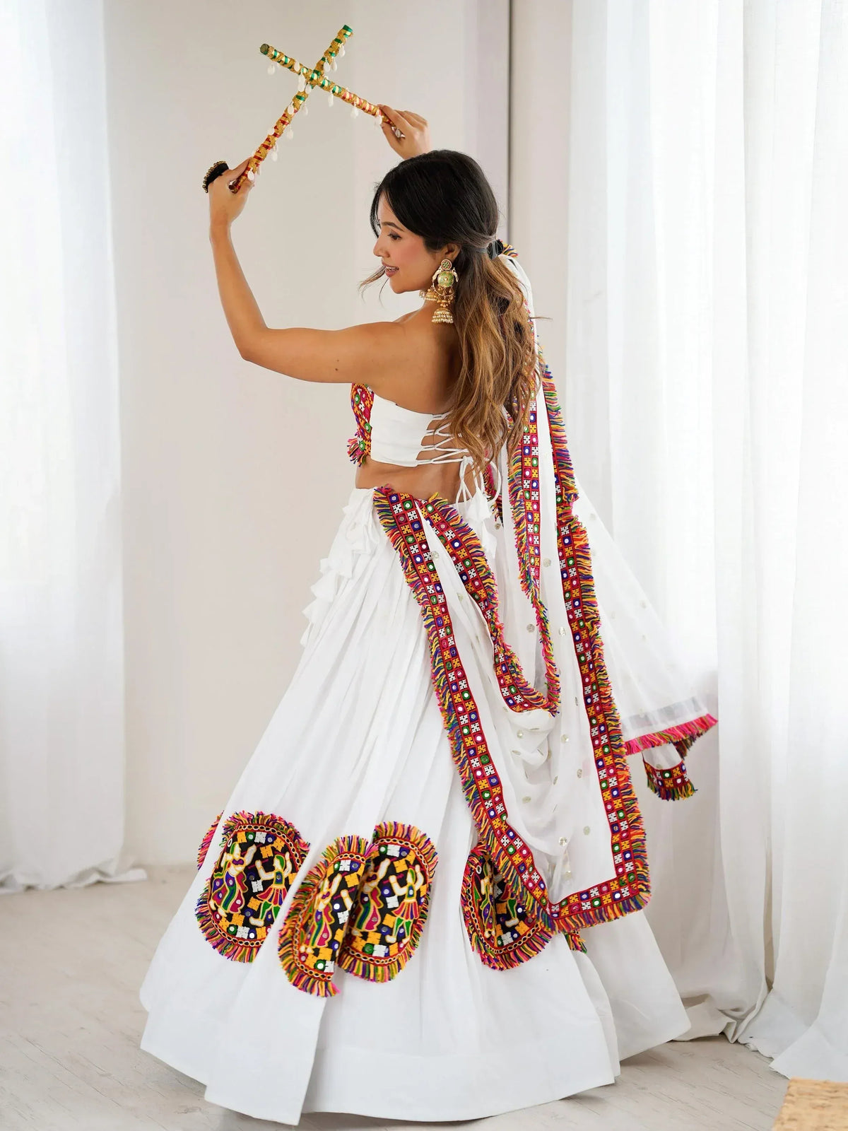 White embroidered lehenga choli with colorful mirror work, perfect for Indian ethnic wear and festive occasions.