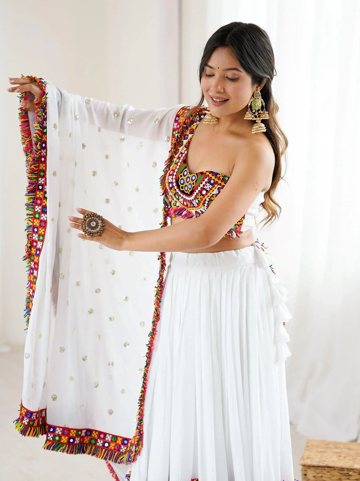 White ethnic lehenga with colorful mirror work and dupatta, perfect for Indian festivals and weddings