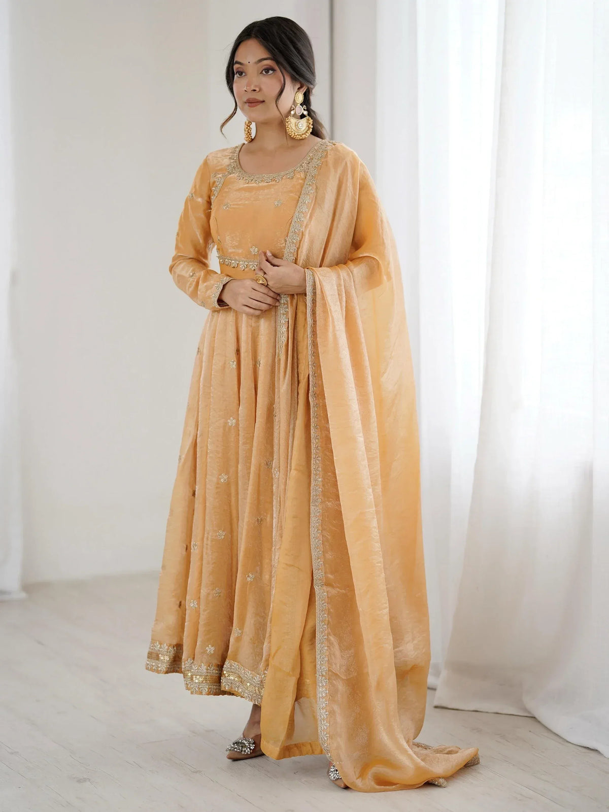 Elegant mustard yellow ethnic anarkali suit with gold embroidery, perfect for Indian occasions and festive wear.