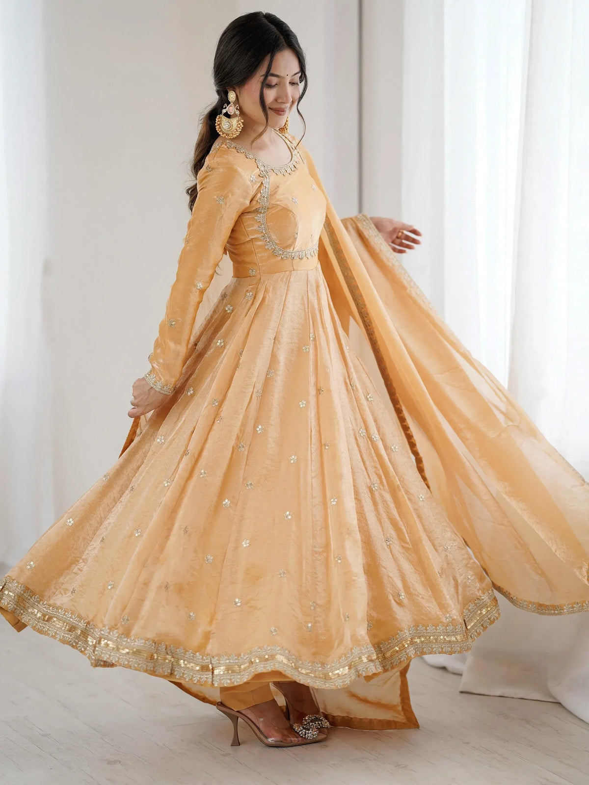 Elegant mustard yellow anarkali with floral embroidery and gold trim, perfect for Indian ethnic wear.