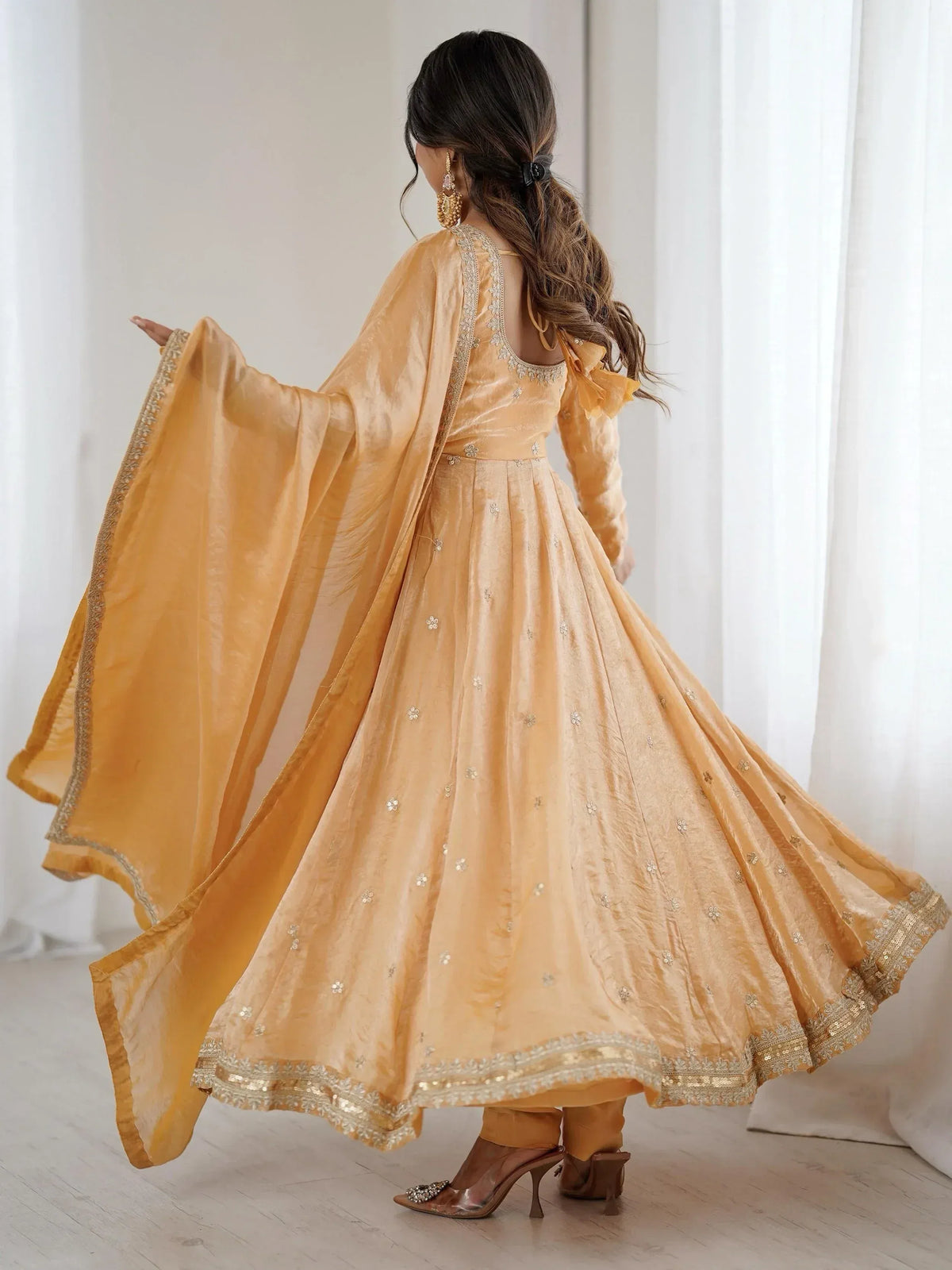 Elegant mustard yellow anarkali suit with floral embroidery, flowing dupatta, and gold trim, perfect for Indian ethnic wear.