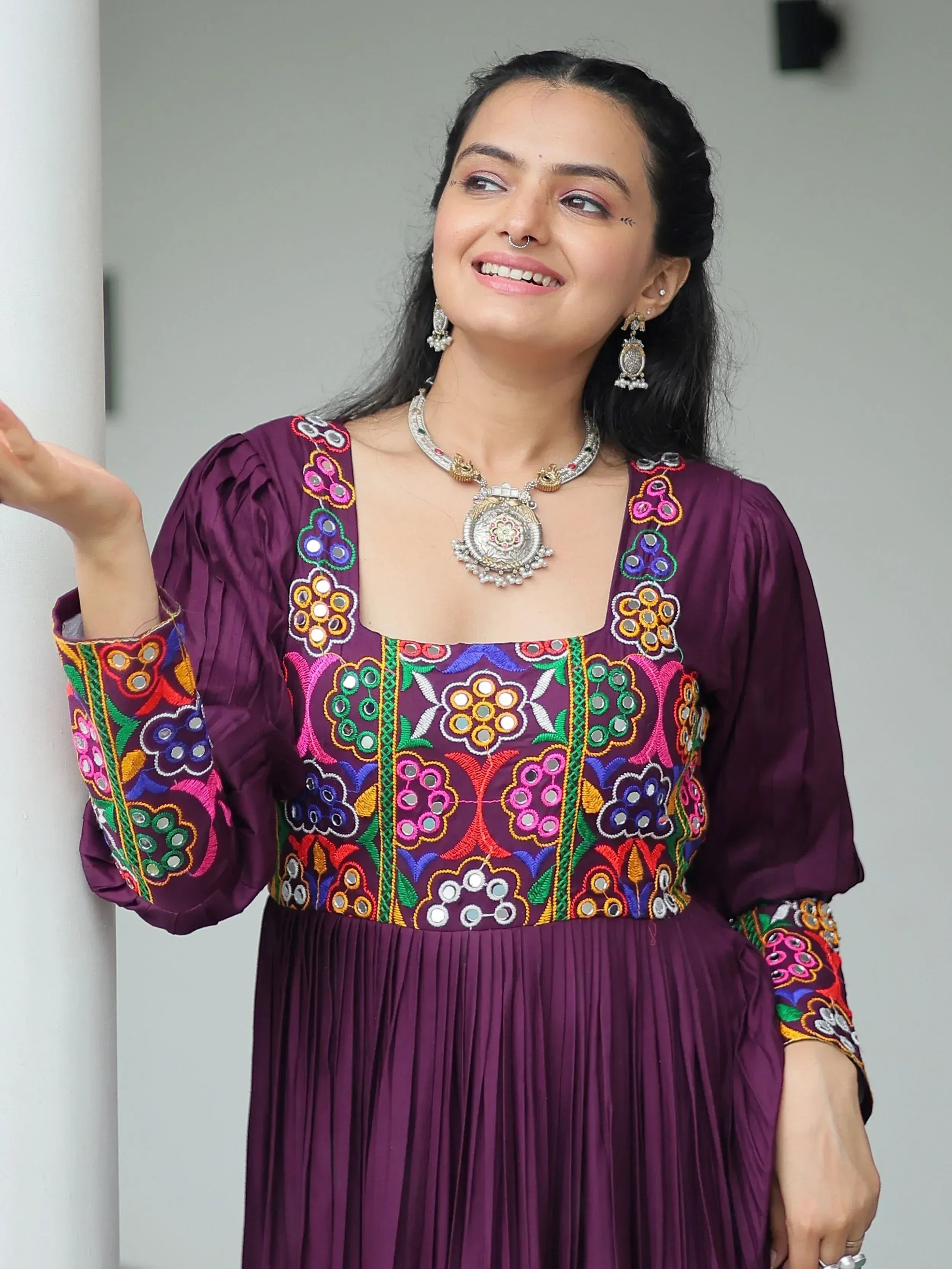 Purple ethnic gown with colorful mirror embroidery, perfect for Indian festive occasions