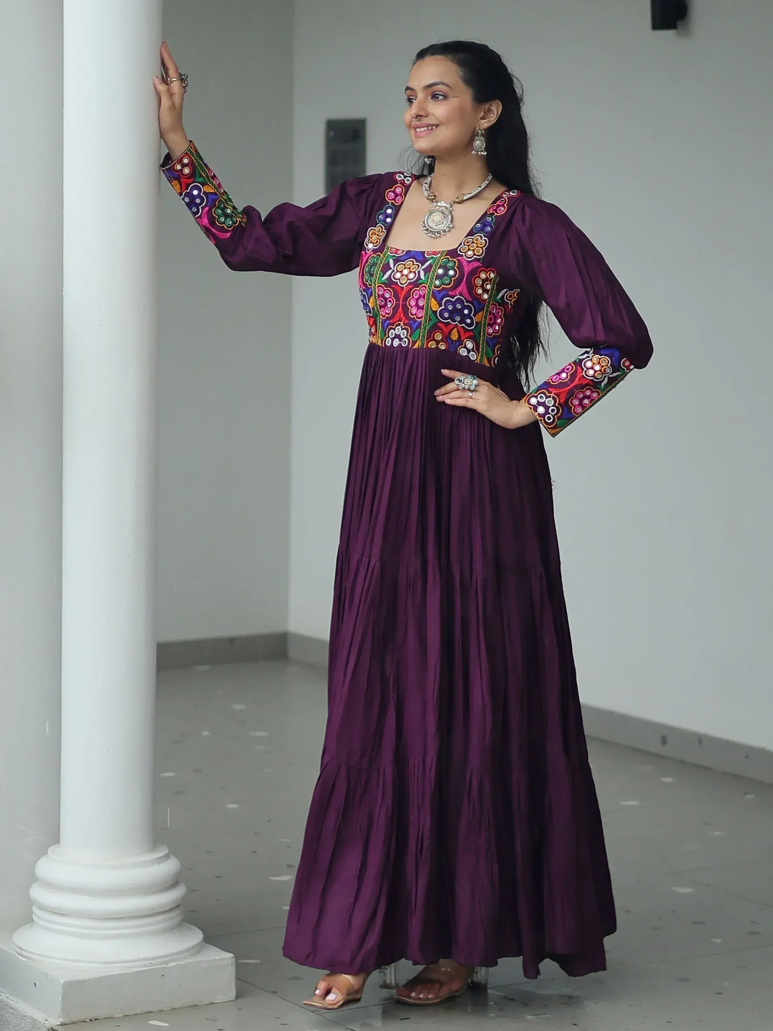 Purple ethnic gown with colorful floral embroidery, long sleeves, and pleated skirt for women