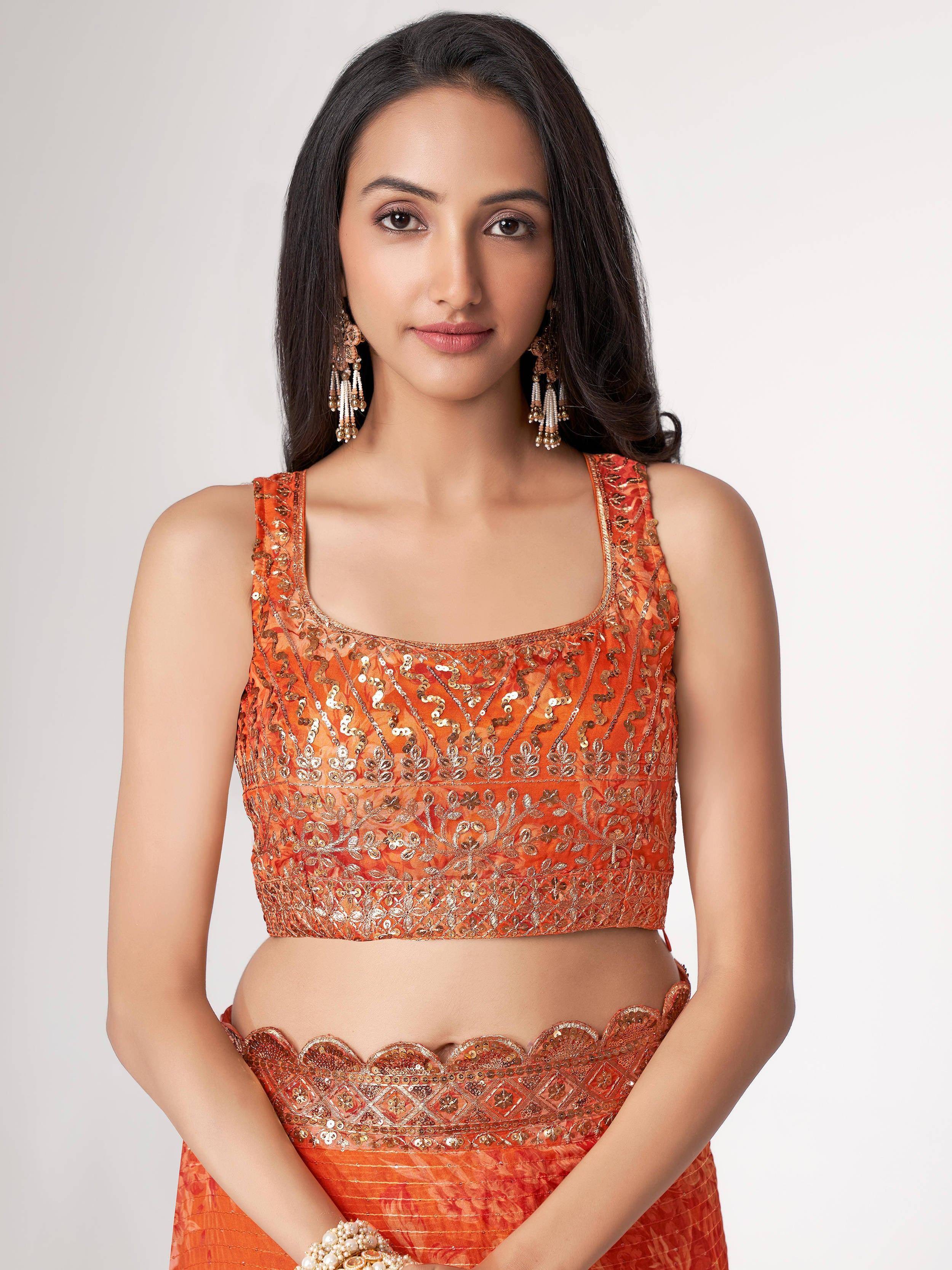 Orange sequin-embellished lehenga choli with scalloped waistband, perfect for Indian ethnic wear occasions