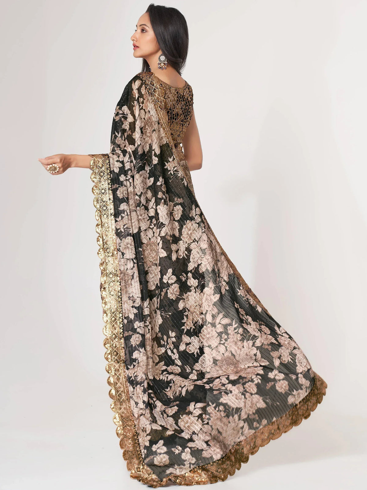 Elegant black and gold floral printed ethnic gown with detailed embroidery, perfect for festive occasions.