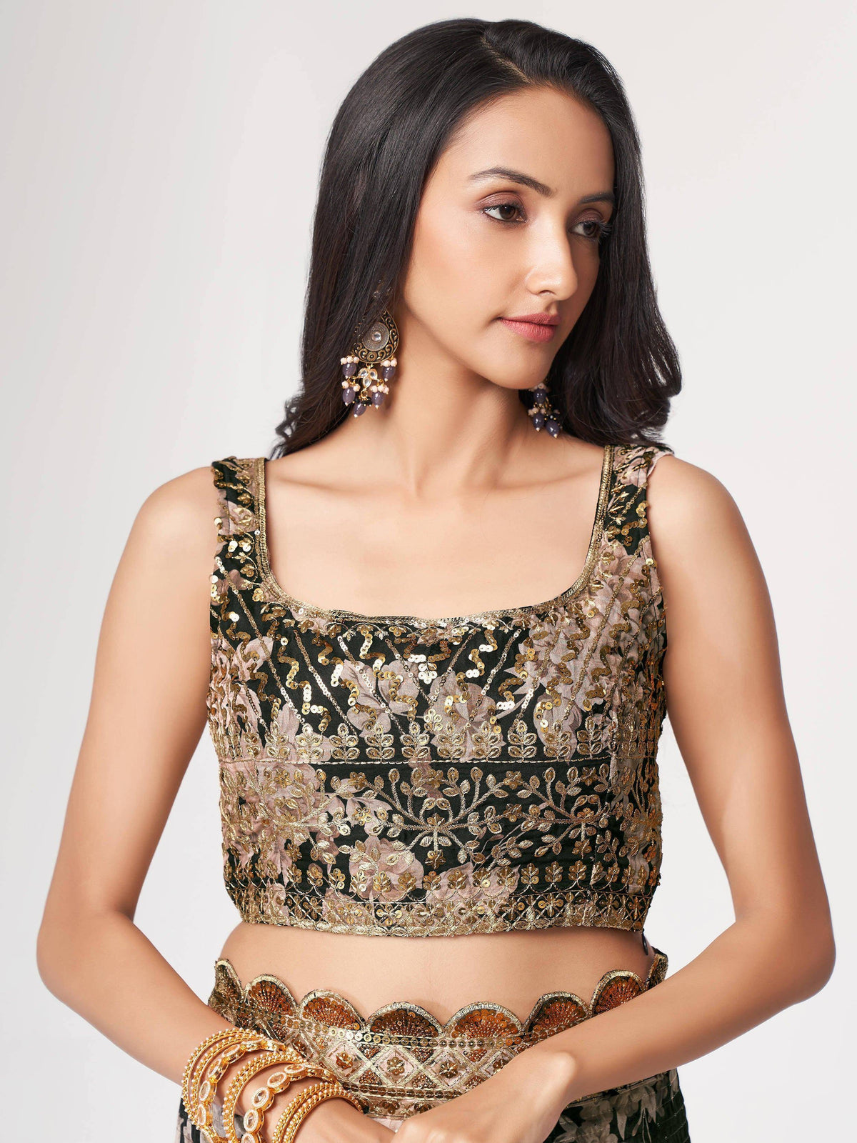 Elegant black and gold embroidered lehenga choli blouse with floral sequin work and matching jewelry