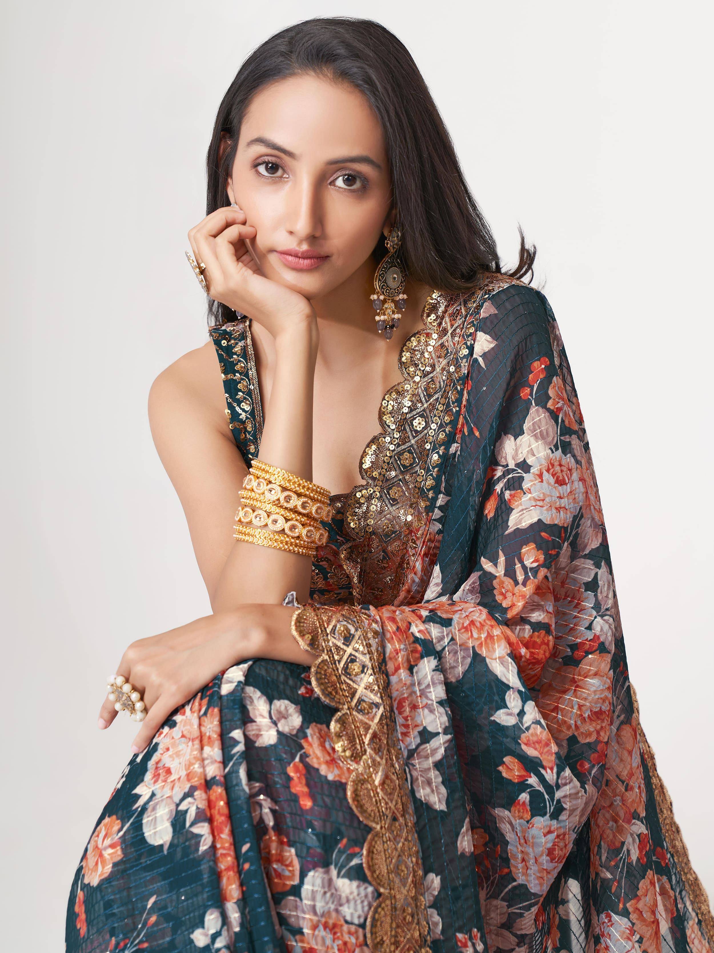 Woman in floral Indian ethnic gown with gold embroidery and traditional jewelry