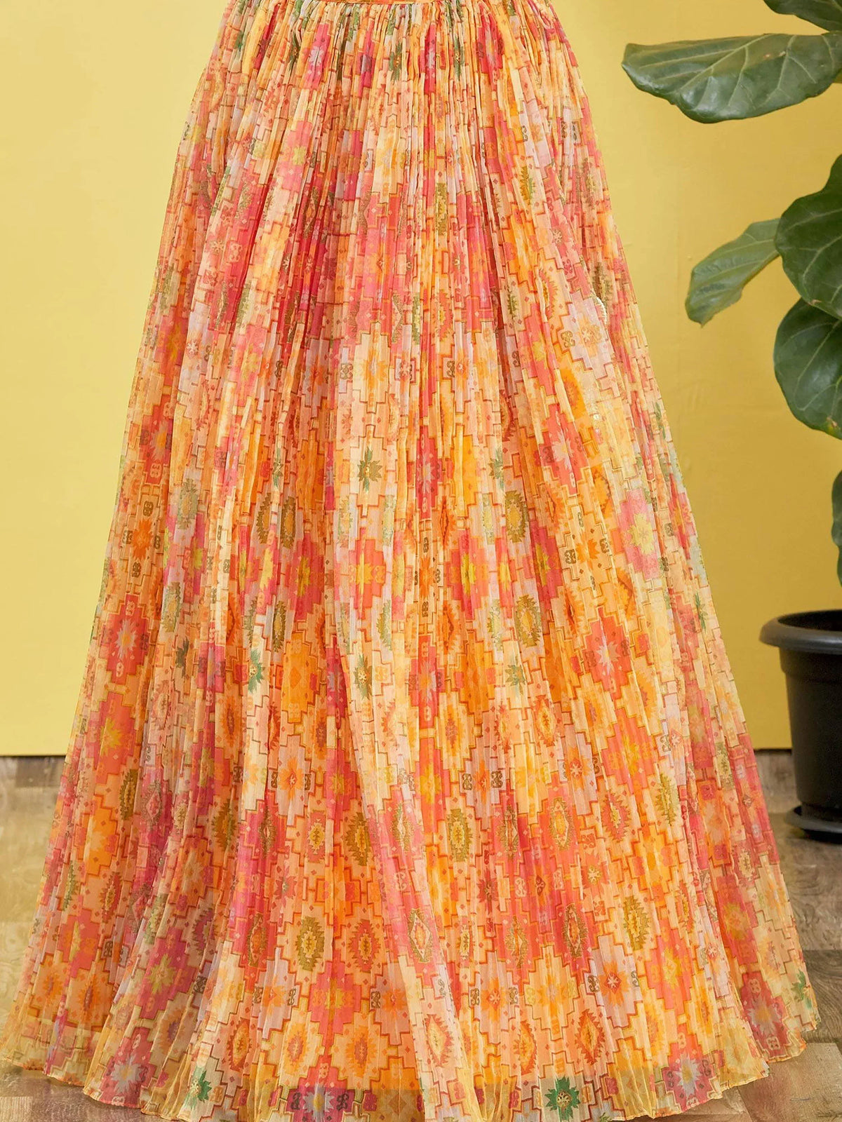 Vibrant pleated ethnic skirt with geometric print in orange and pink tones