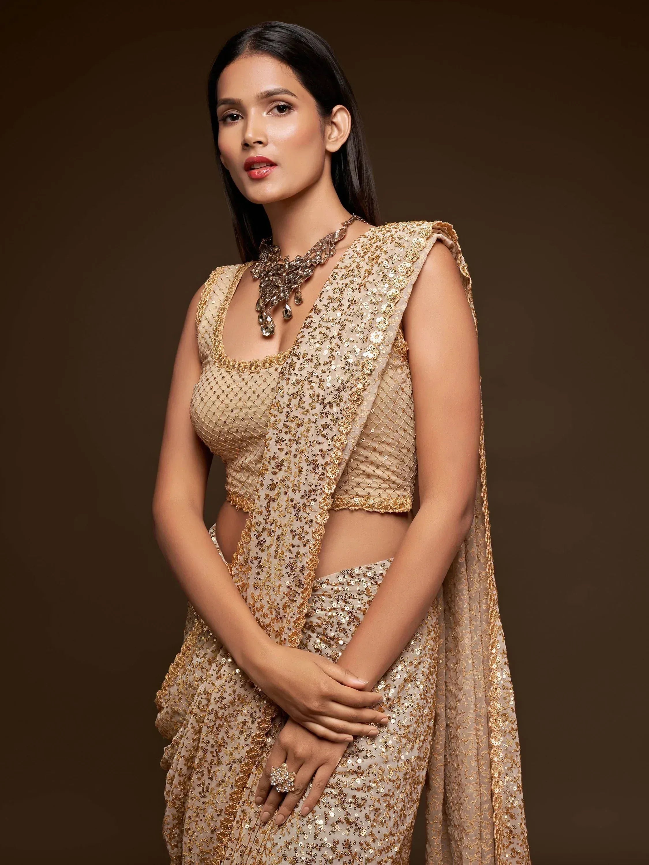Elegant gold sequin lehenga choli with matching dupatta, perfect for Indian ethnic wear occasions.
