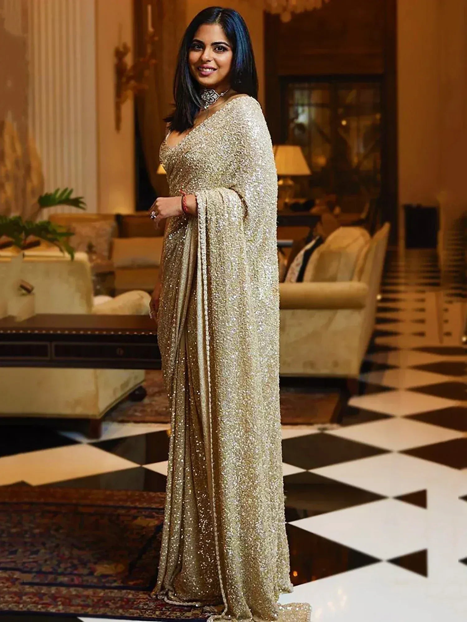 Glittering gold sequin saree with cape sleeve, perfect for Indian ethnic events and weddings