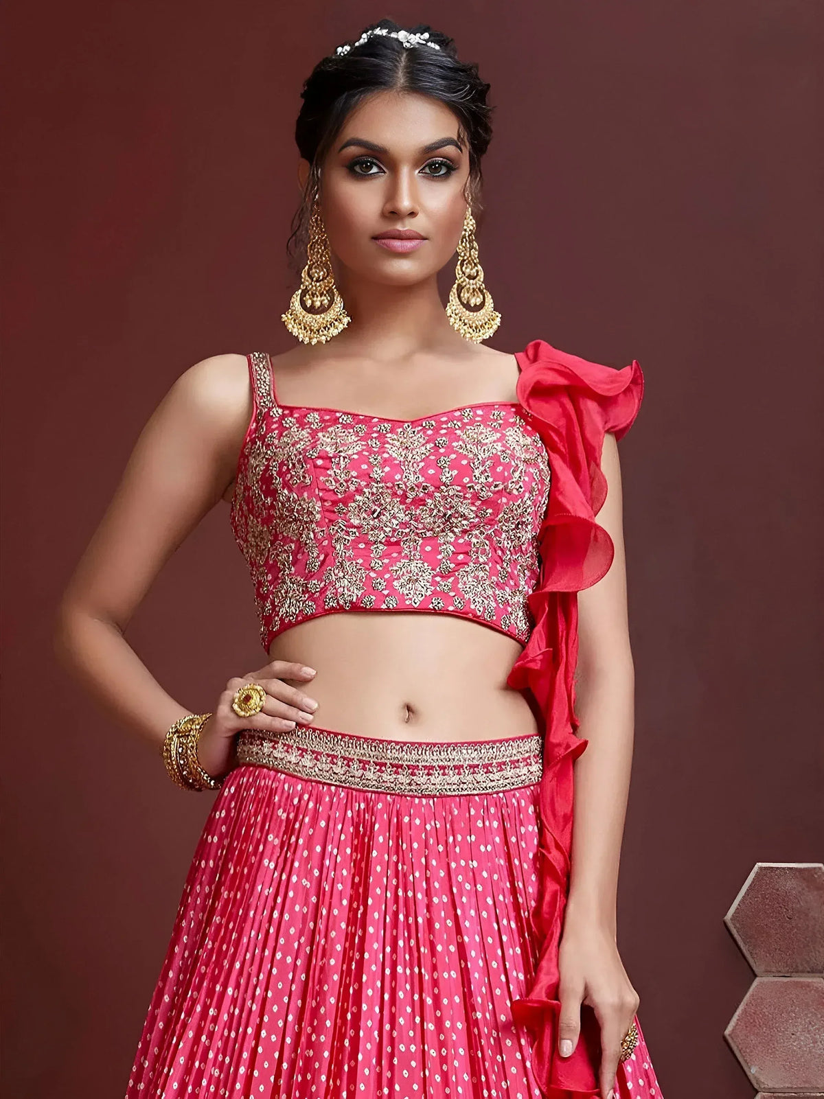 Pink embroidered lehenga choli with ruffled sleeve, gold jewelry, perfect for Indian ethnic wear occasions
