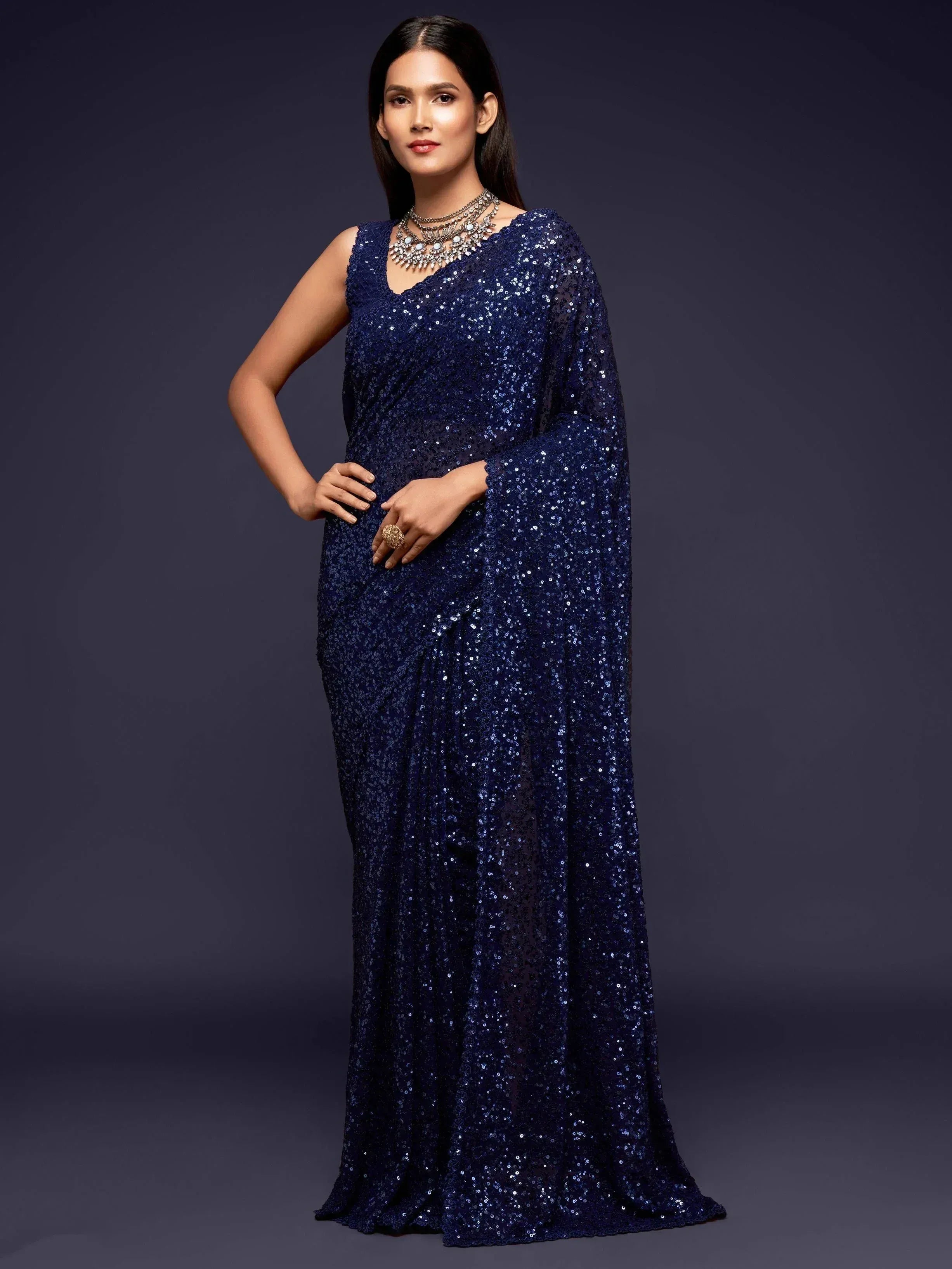 Navy blue sequin saree with sleeveless blouse, perfect for Indian ethnic wear events