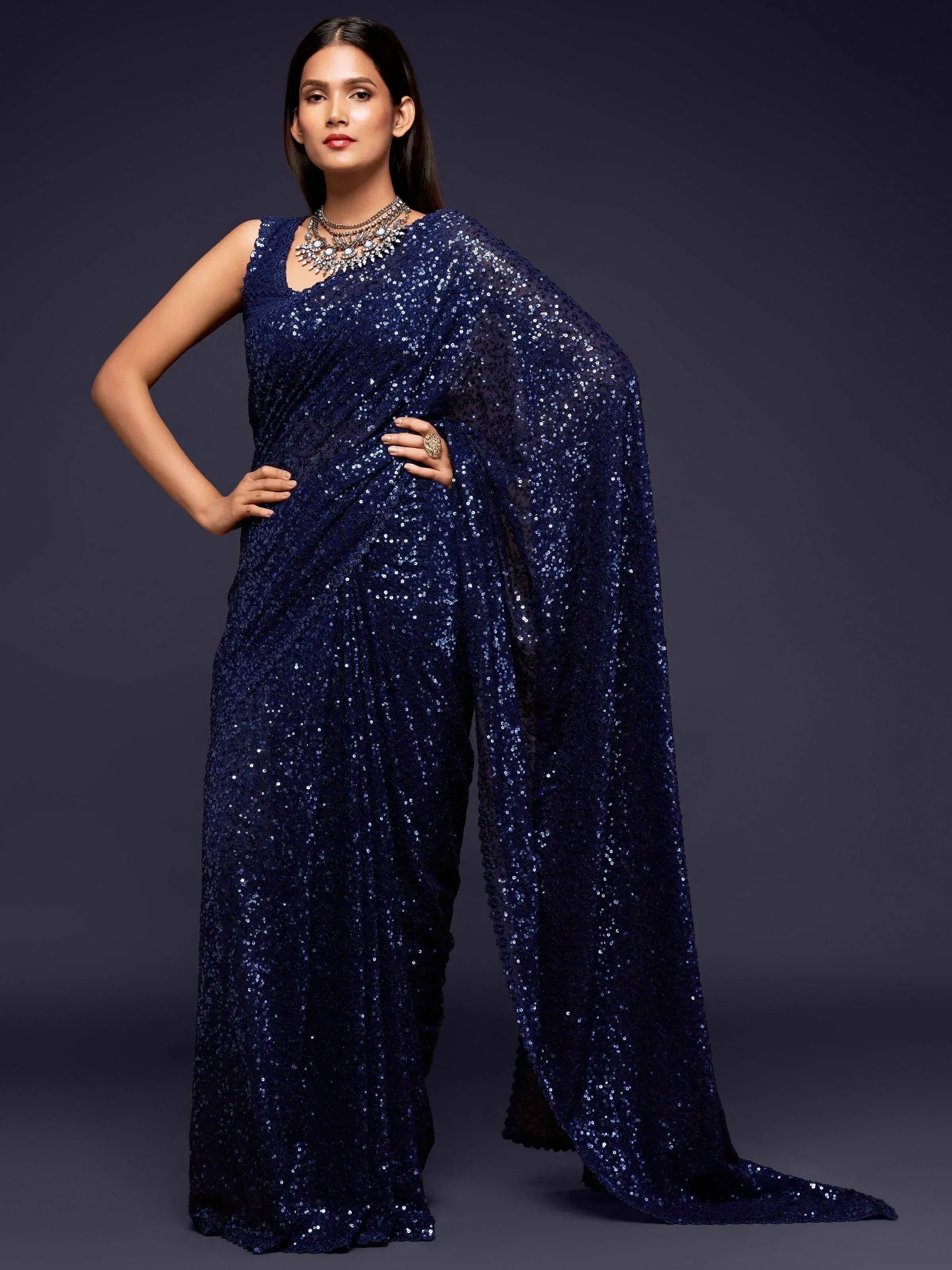 Navy blue sequin saree with sleeveless blouse, perfect for Indian ethnic wear events