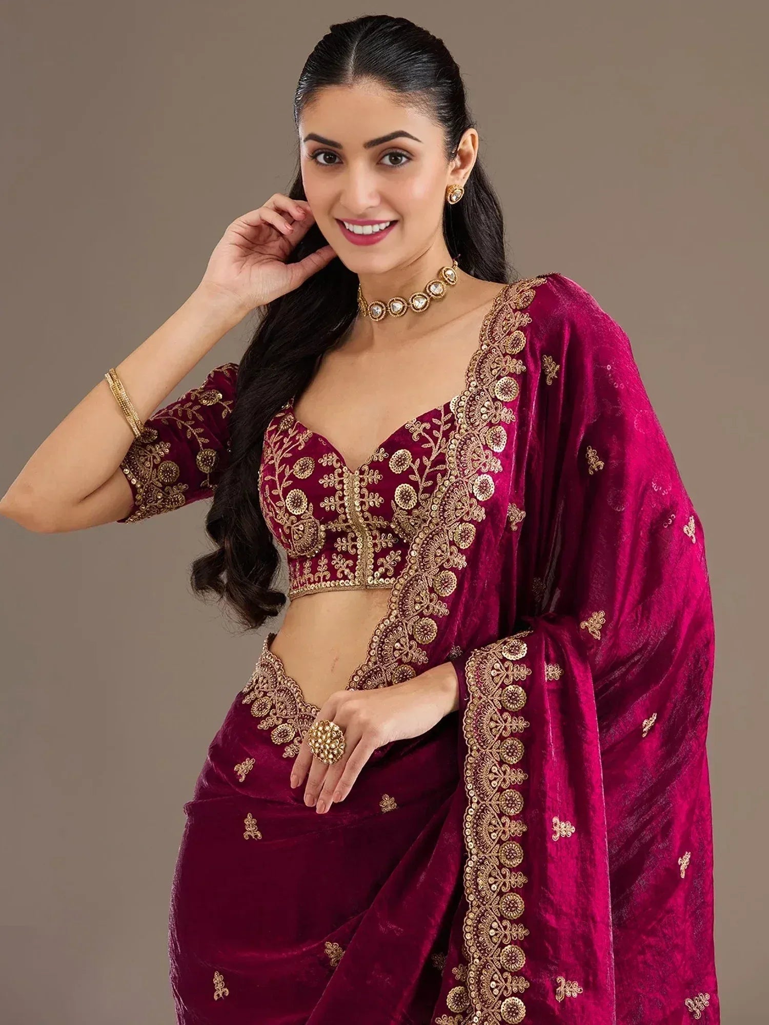 Burgundy velvet lehenga choli with gold embroidery, perfect for Indian ethnic wear and festive occasions.