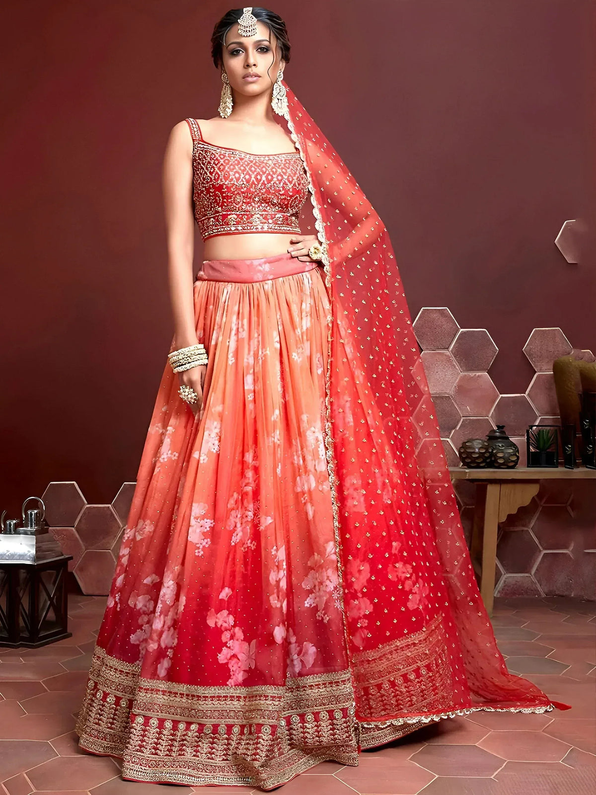 Red and peach floral lehenga choli with gold embroidery, perfect for Indian weddings and festive occasions.