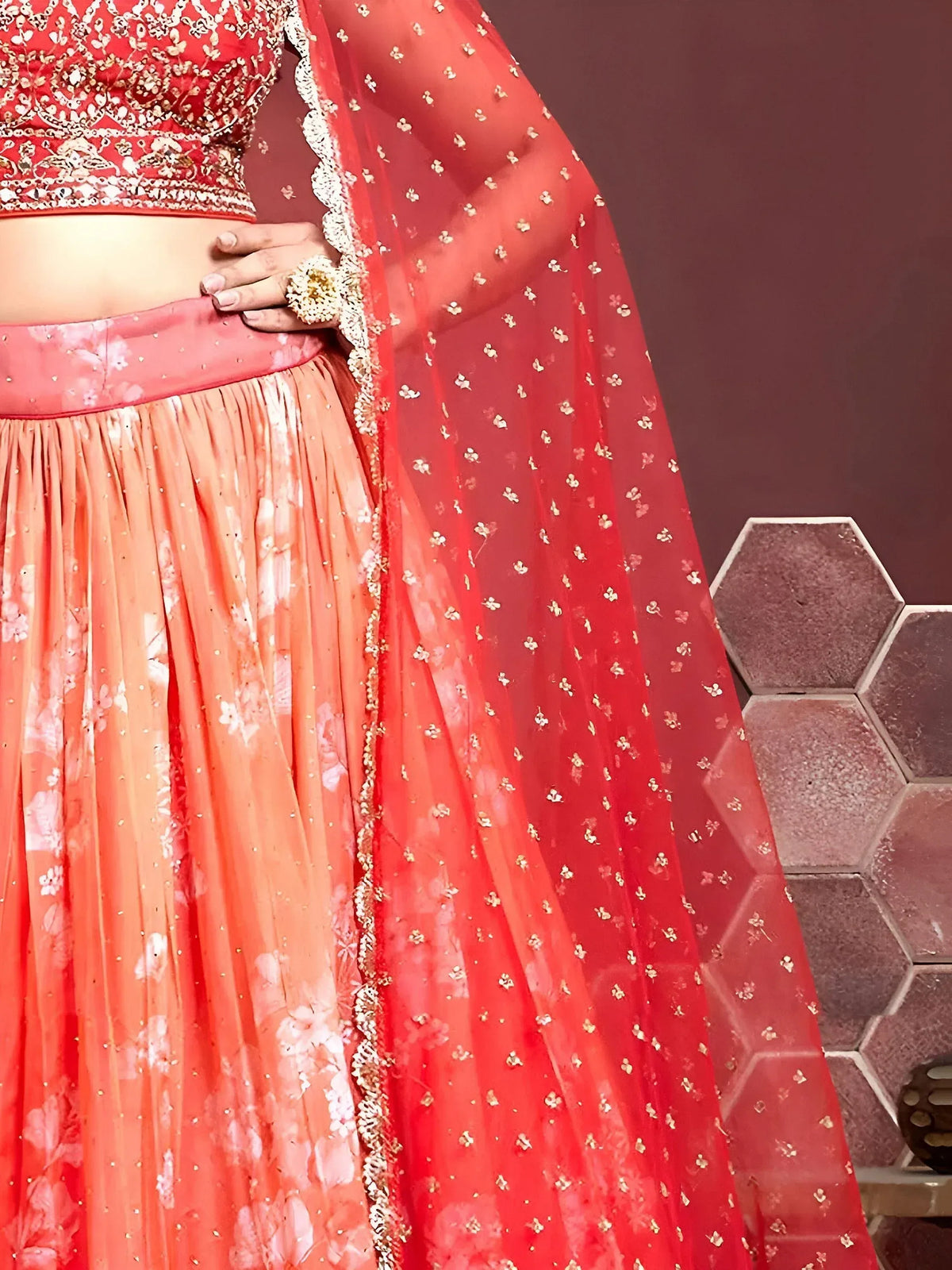 Red and peach embroidered lehenga choli with floral print skirt and sheer dupatta, perfect for Indian weddings.