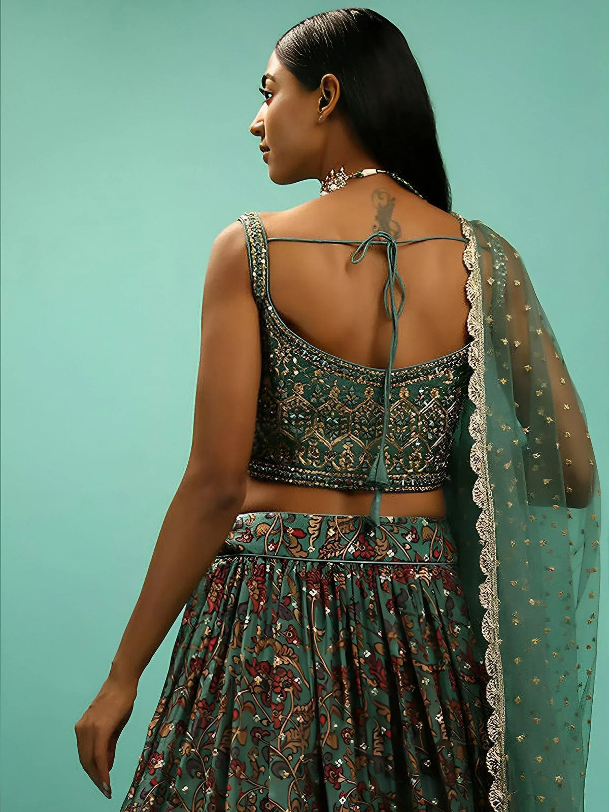 Elegant green lehenga choli with intricate embroidery and back tie design