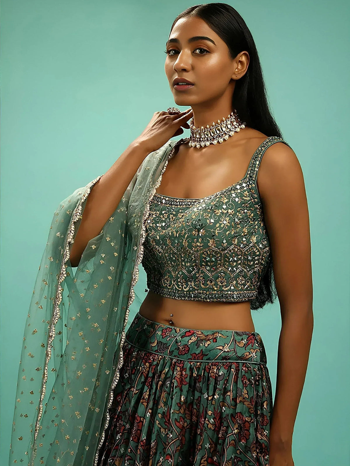 Elegant green embroidered lehenga choli with floral skirt and matching dupatta, perfect for Indian ethnic wear.