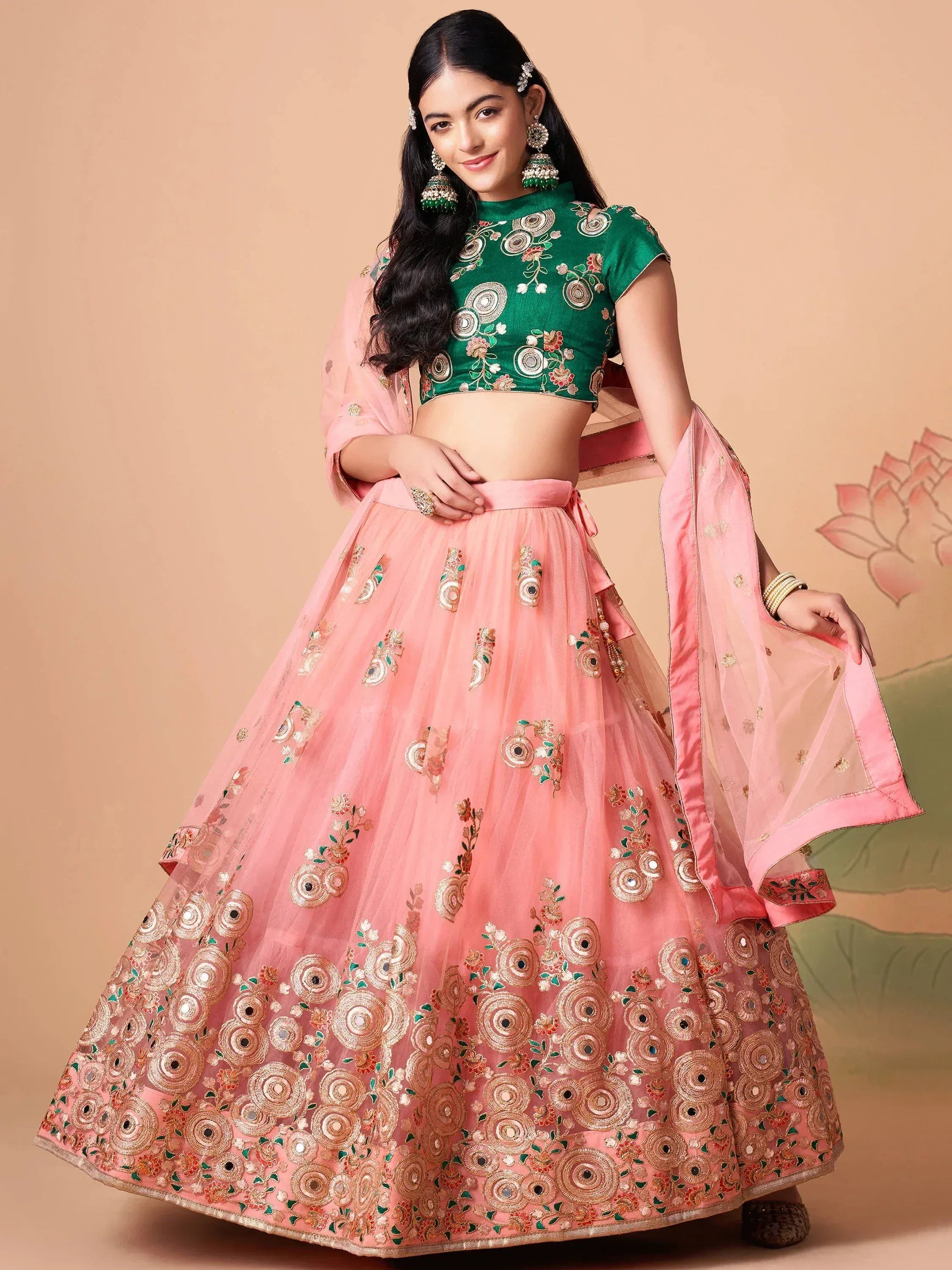 Pink embroidered lehenga choli with green blouse, perfect for Indian weddings and festive occasions.